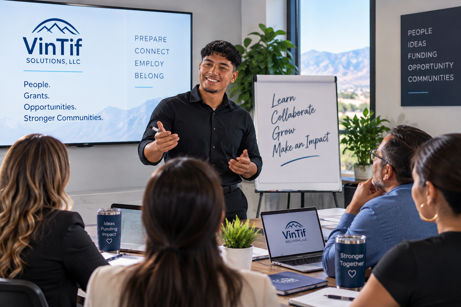 A man giving a presentation to a group of people in a conference room. There are presentation screens and a flip chart with motivational messages. The room has windows with a mountain view.