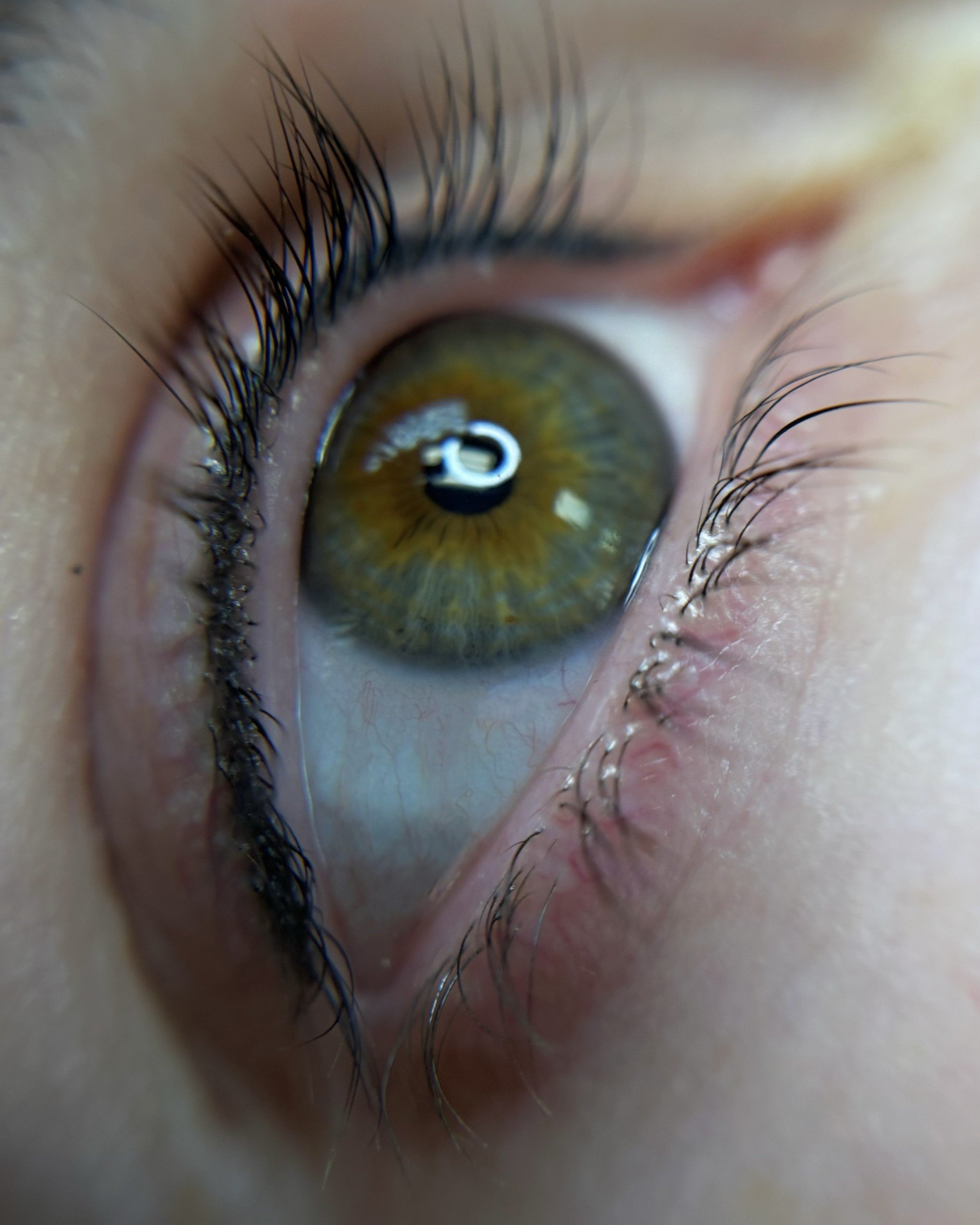 Permanent lash line enhancement tattoo creating subtle eyeliner definition and the appearance of fuller, darker lashes by Adia Tattoo in San Diego.