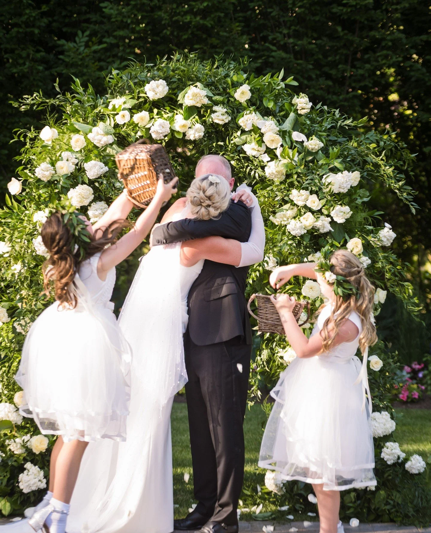 The flower girls understood the assignment. 🌿🤍⁠
⁠
Just when the newlyweds thought the ceremony was over, these two made sure their first kiss as husband and wife was celebrated with a shower of petals and a little extra magic.⁠
⁠
Planner &amp; Desi