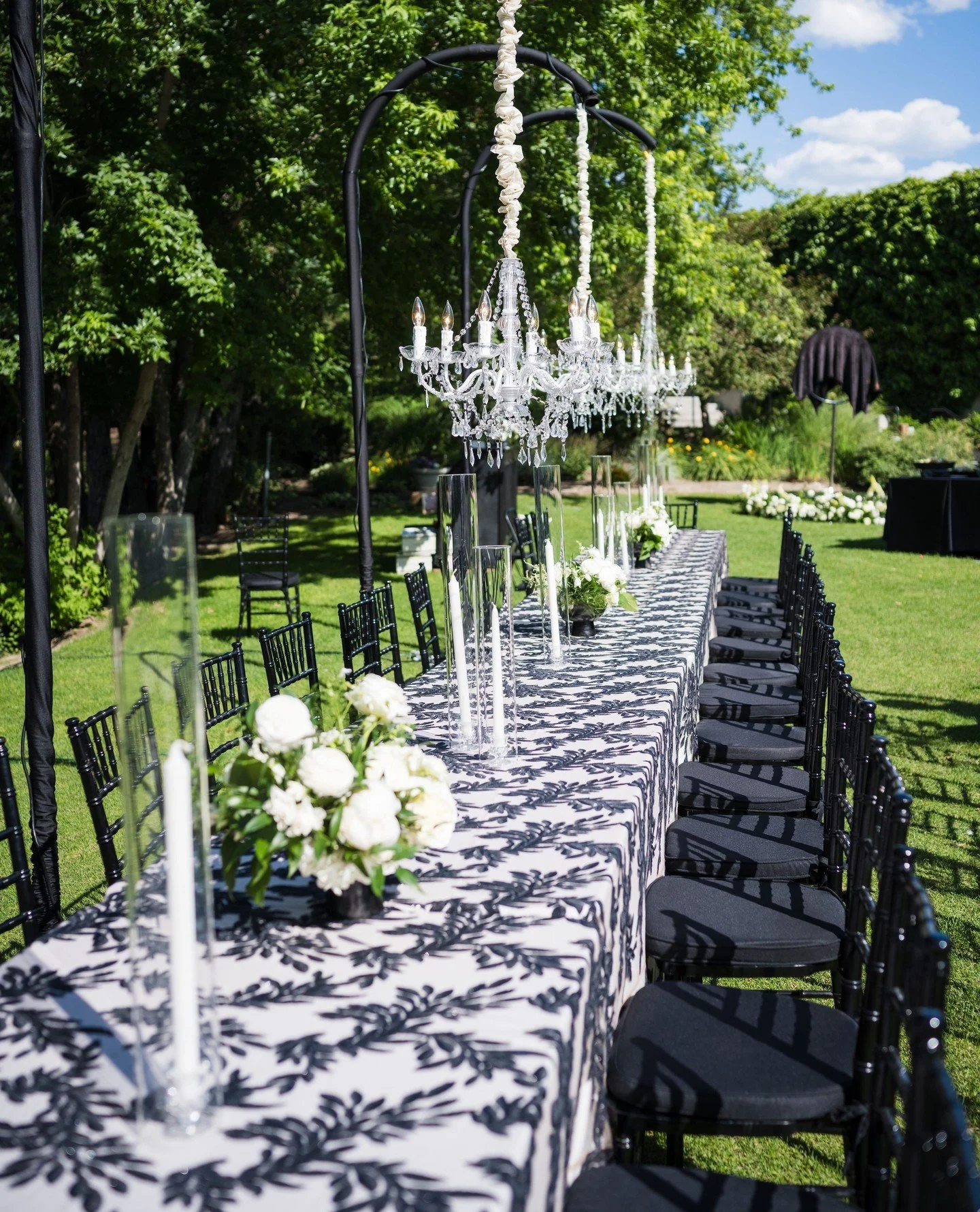 A garden reception, reimagined.⁠
⁠
Layers of black and ivory, flowing draping overhead, and florals that softened every line. Every detail felt unexpected, yet completely at home beneath the trees.⁠
⁠
Planner &amp; Design: @irenecoevents⁠
Hair: @paul