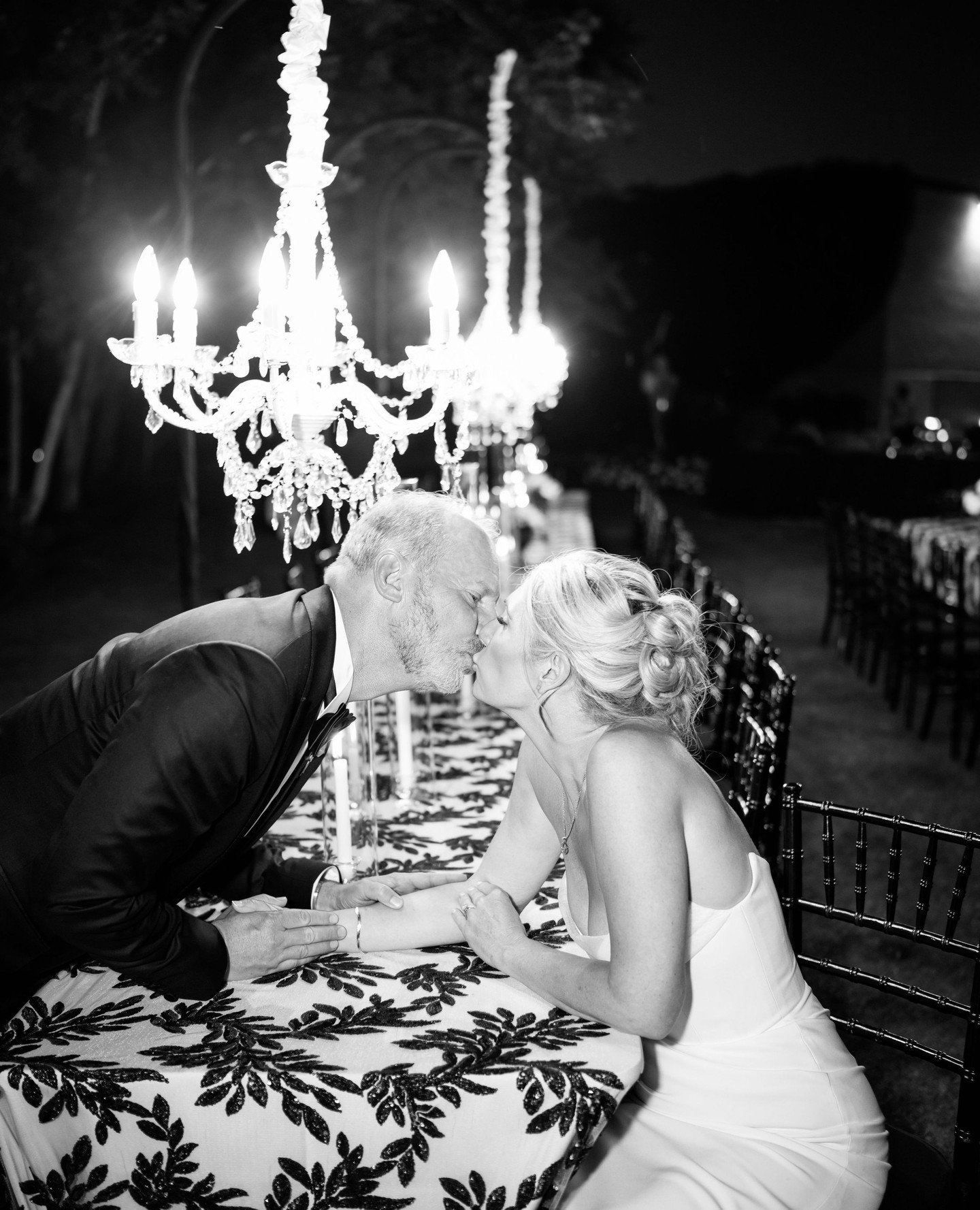 As the sun set, crystal chandeliers reflected across the water, black and ivory textures filled the garden, and dinner began beneath the open sky.⁠
⁠
Planner &amp; Design: @irenecoevents⁠
Hair: @paulinesansom⁠
Rentals: @summitpartyrentals_ut⁠
Ceremon