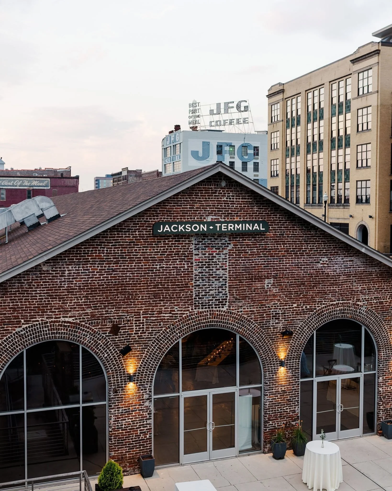 Exterior of Jackson Terminal, a historic brick event venue in Knoxville’s Old City, featuring arched windows and the Jackson Terminal sign.