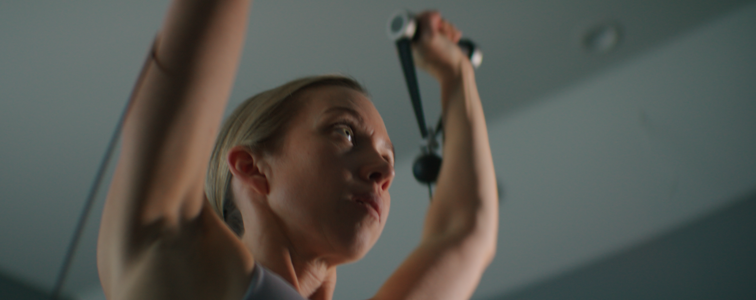Person exercising with resistance bands, focused expression