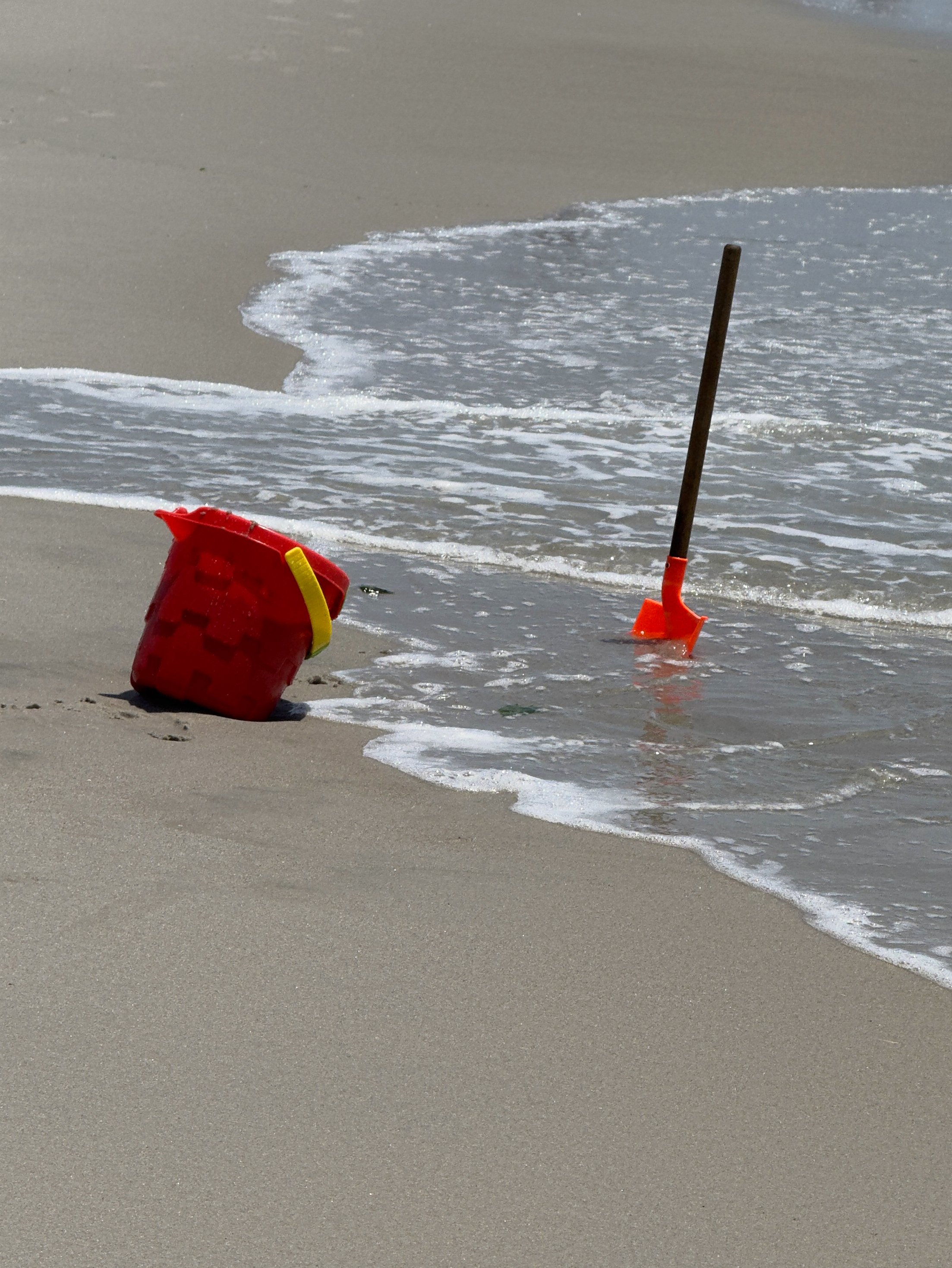 Bucket and a shovel in the sand - Photograph by Noemi Moreno