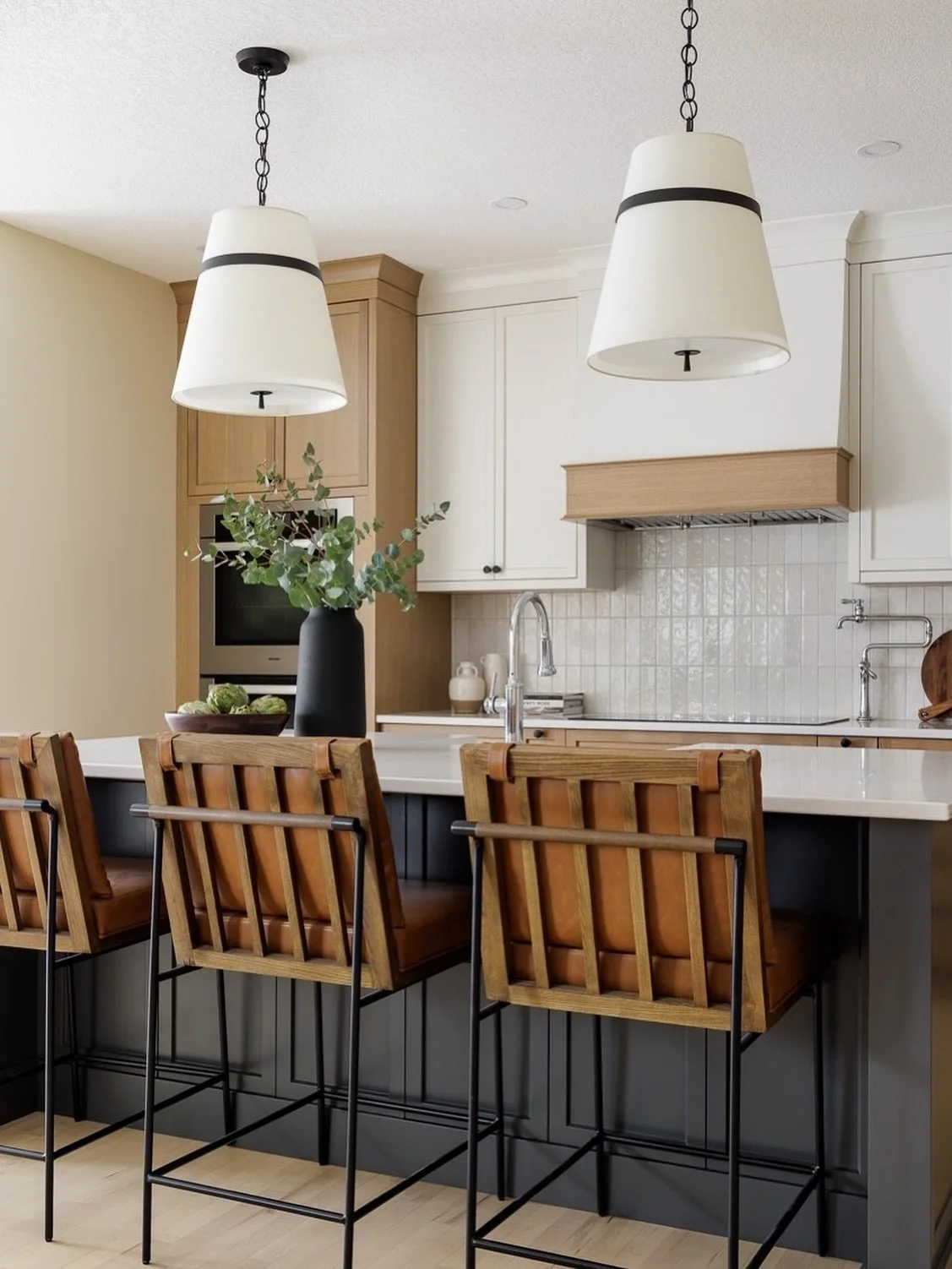 Scale. The larger scale pendant lights above the island at #AVDCougarRidge work well to fill the space since we opted to go with 2 instead of 3 or 4. It&rsquo;s a nice way to switch things up. 
⠀⠀⠀⠀⠀⠀⠀⠀⠀
Interior Design: @Designs_AV
Photography: @kla