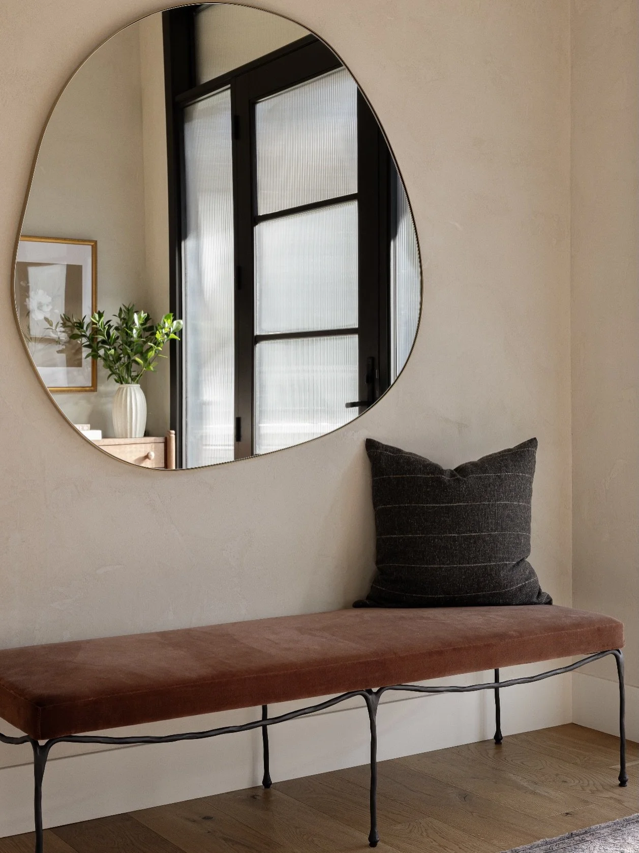 Entry moments matter. We reimagined the entry at #AVDBritannia with a soft plaster treatment to instantly elevate and welcome. Sculptural additions&mdash;a metal bench, an oversized organic mirror, and a warm wood console&mdash;layer together to crea