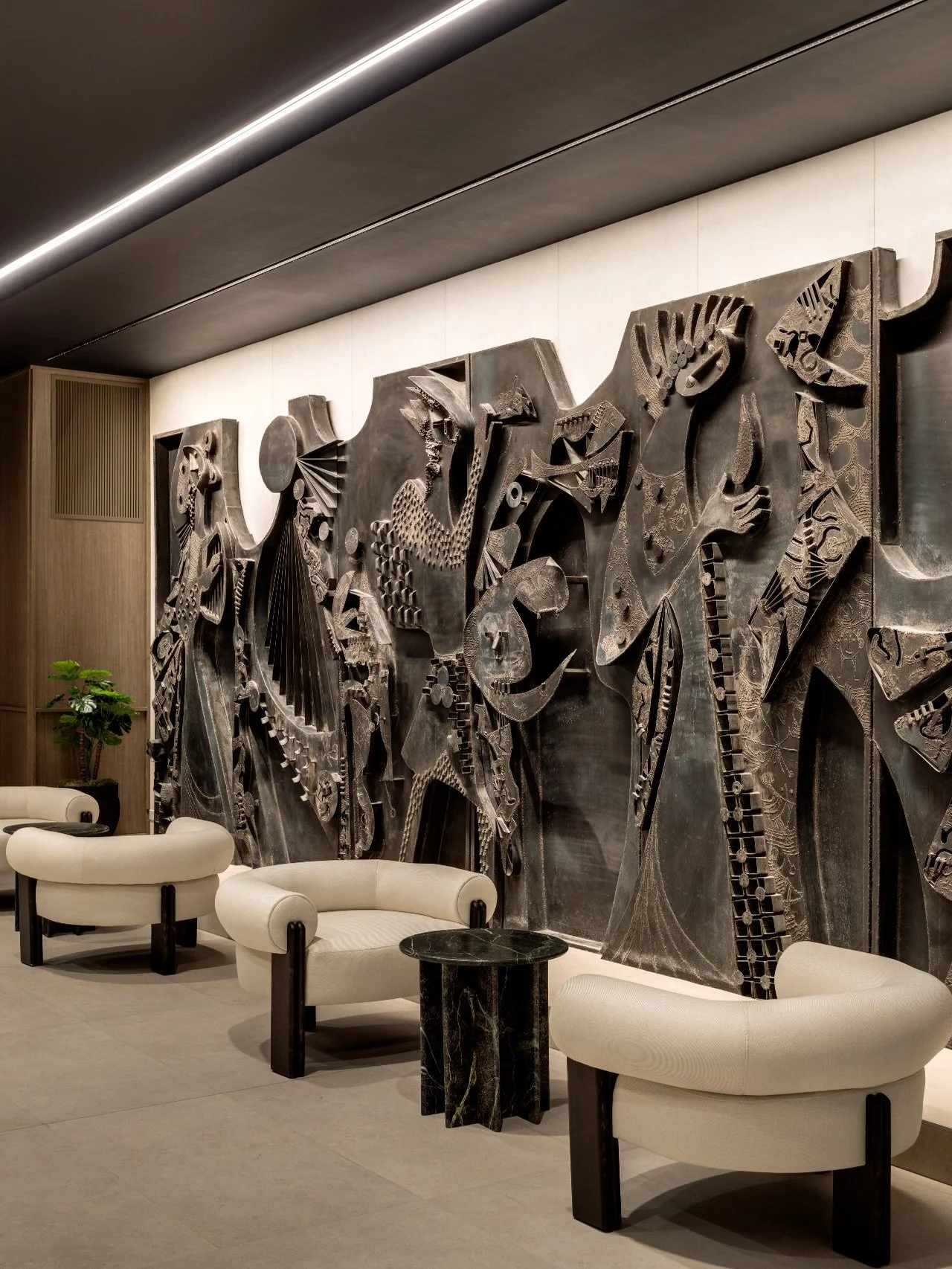 Lobby. Inspired by the original metal mural Pan and the Three Graces by #KrystynaSadowska, the lobby at #CalgaryHouse is designed as a warm, expressive moment. Anchored by this powerful artwork, the space was intentionally composed to make the mural 