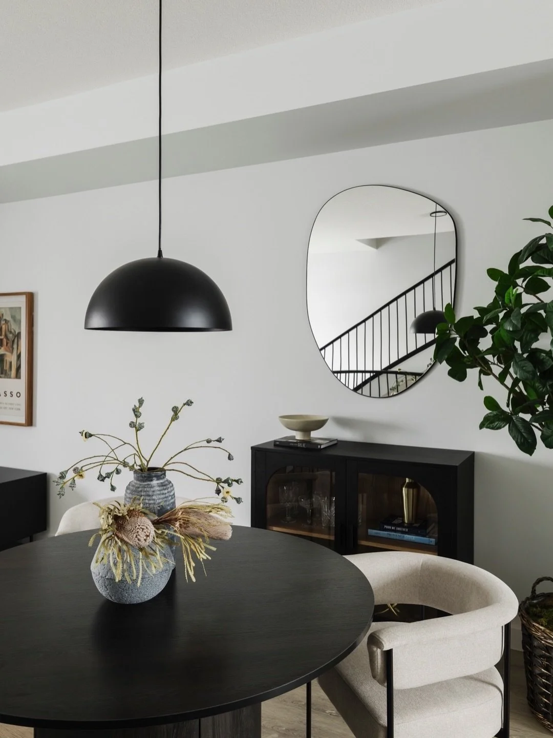 Nook. This intimate dining nook is serving all the dark and moody vibes. By opting for a round table to enhance flow, the space feels intentional and seamlessly integrated &mdash; a cozy moment that feels like a true part of the home, not an aftertho