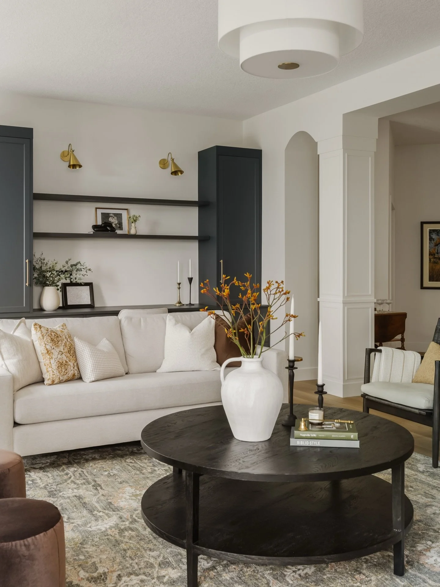 Office. We created a built-in office moment within the living room to make the most of the extra space. Finished in a rich, deep blue, the custom millwork adds visual interest to the back wall while offering generous storage and a beautifully integra