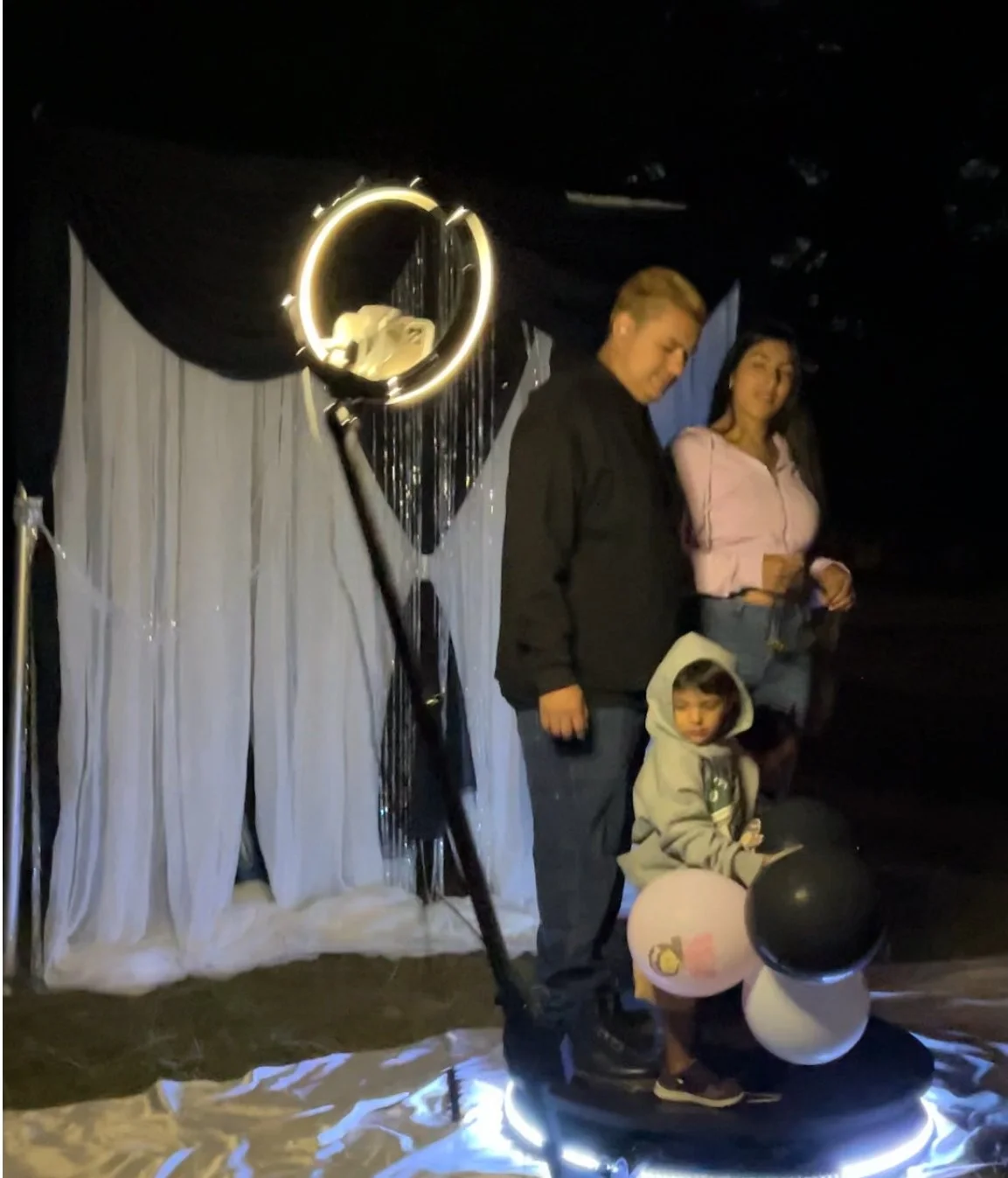 A family sharing smiles on the luxury 360 Booth setup — where Moments Planning turns ordinary nights into extraordinary memories.