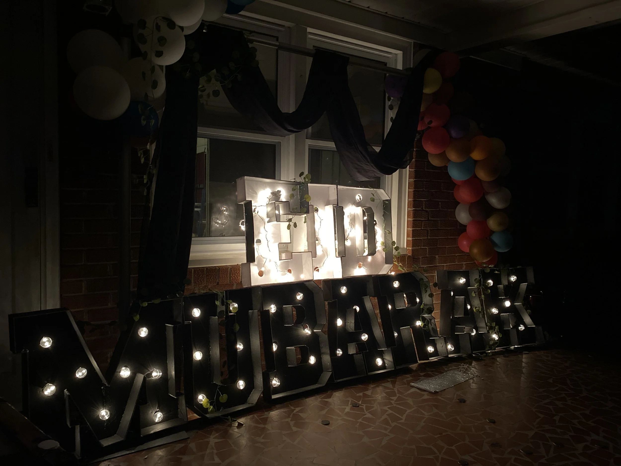 Luxurious black and gold Eid backdrop with marquee lighting, styled for photo-ready moments and elevated cultural celebration.