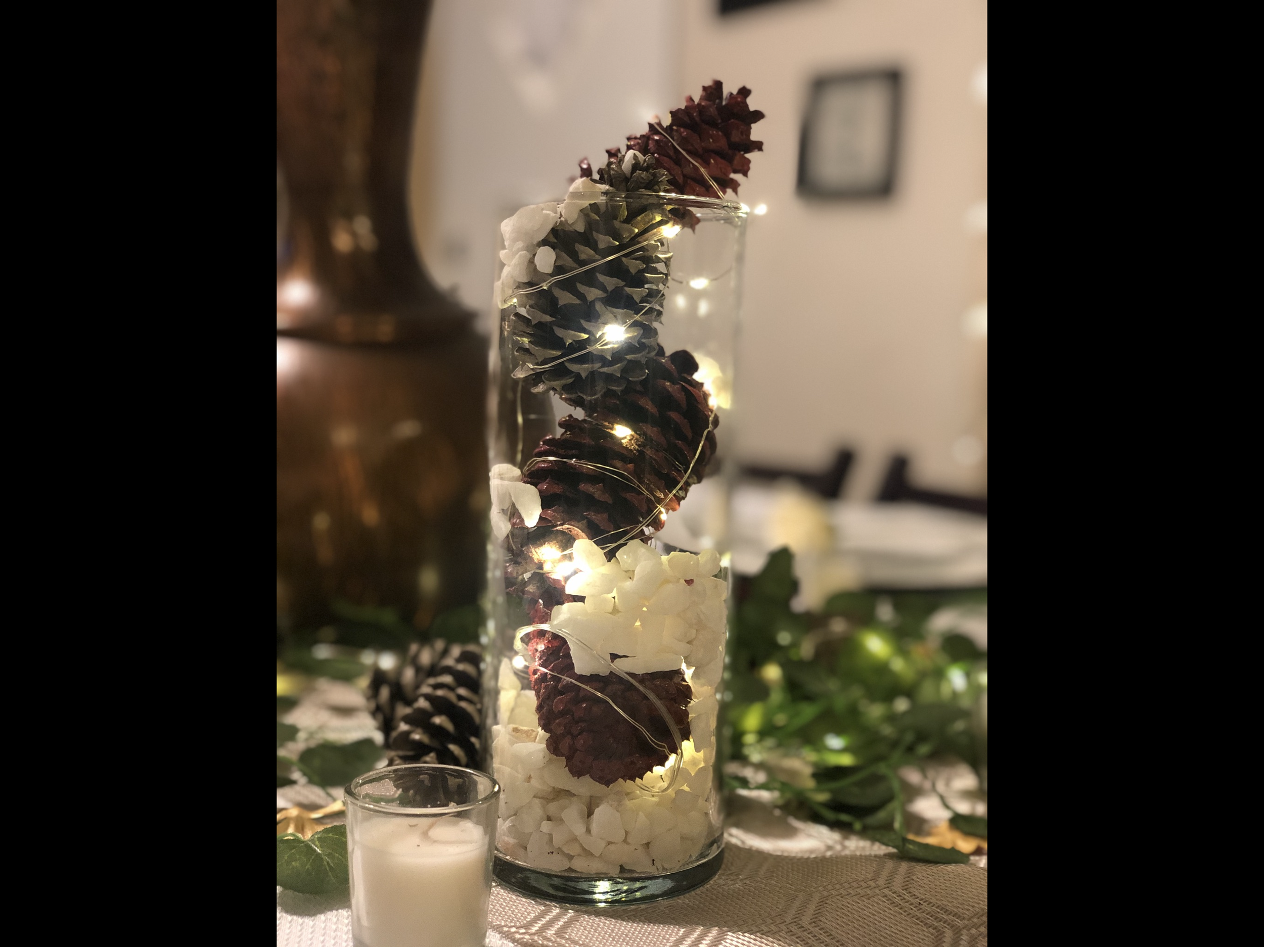 Festive holiday tablescape with black linens, silver accents, and warm lighting — a flawless fusion of cozy and chic.