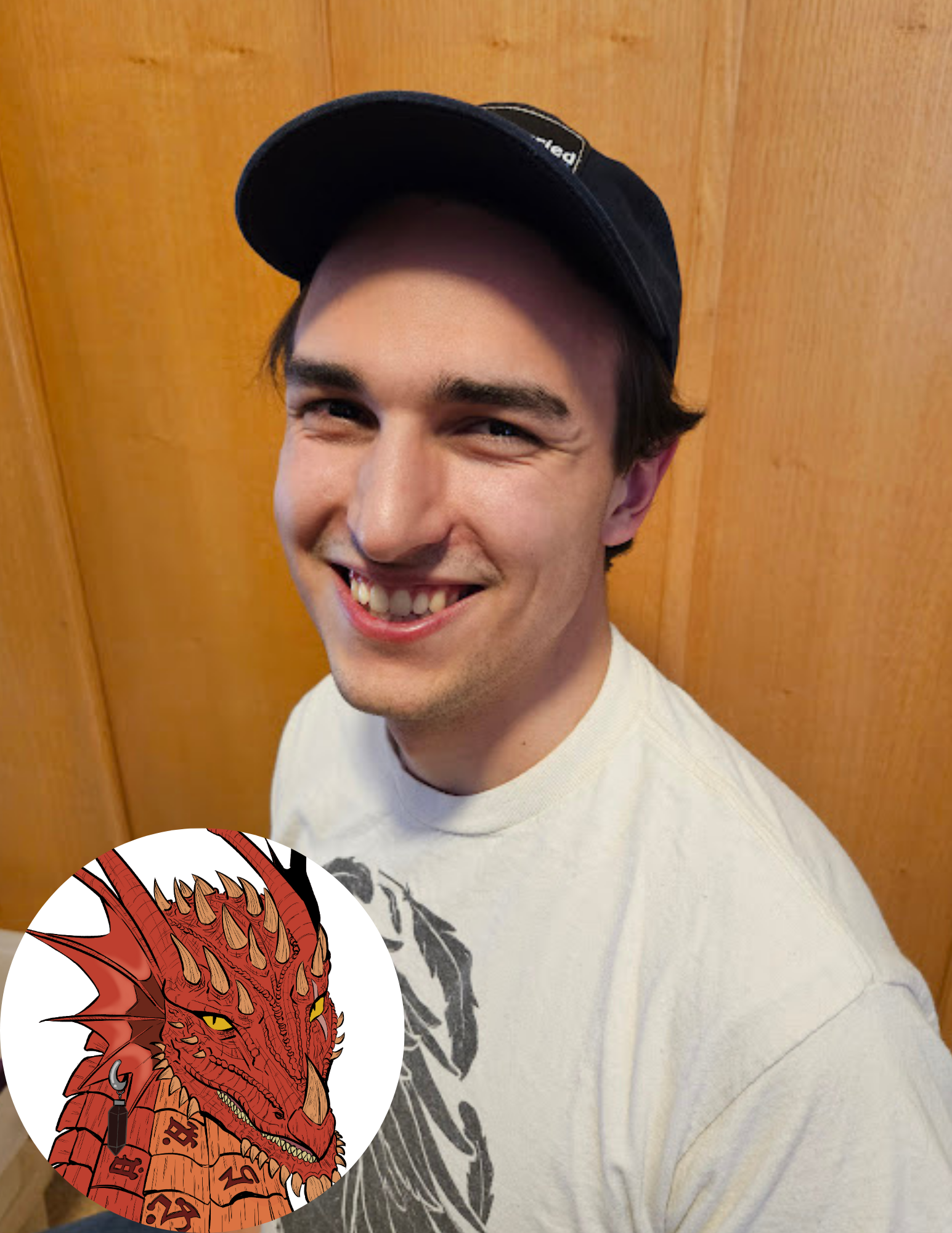 A young man smiling and wearing a black cap, standing in front of a wooden wall. An illustrated red dragon with yellow eyes, horns, and intricate details is overlaid in the bottom left corner.