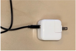 Charging cord connected to wall plug (Copy)