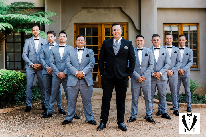 Groomsmen standing with groom for photo