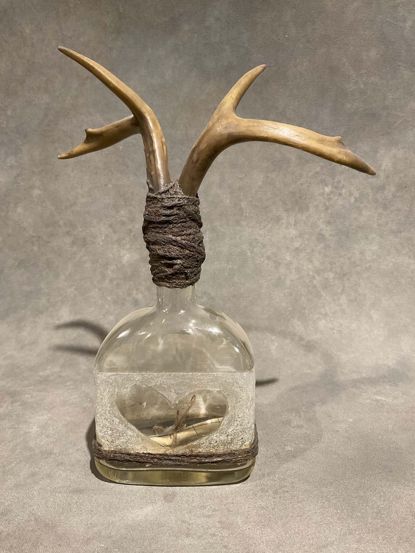 Steve Jensen 
 Message in a Bottle (Antlers)  
13x12x5 
found bottle rope deer antlers vintage nautical chart 
$350