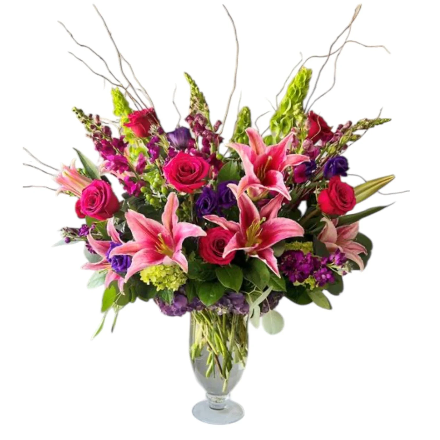 A colorful bouquet of pink lilies, roses, purple flowers, and green foliage in a glass vase.