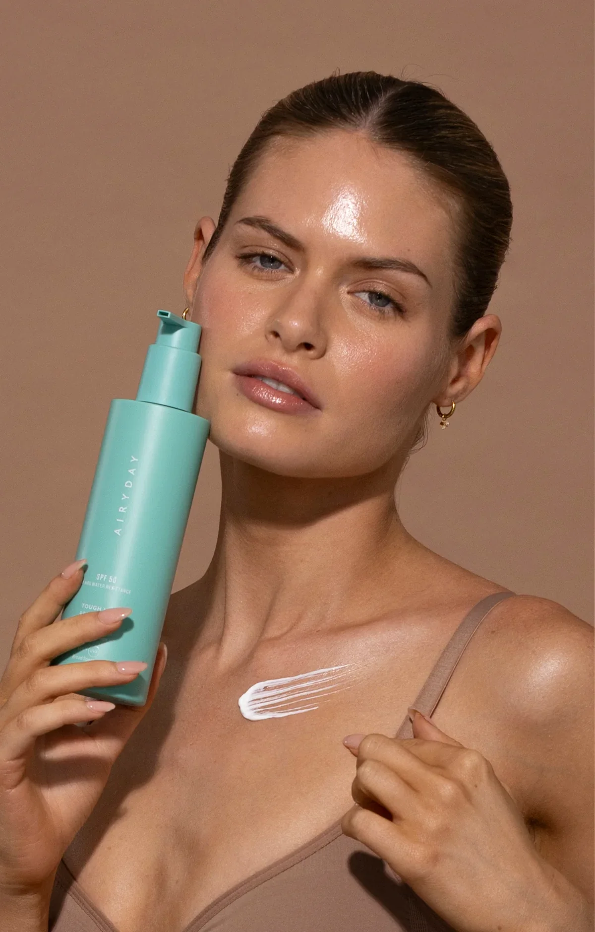 Tough_Luxe_SPF50_Model_with_bottle.webp