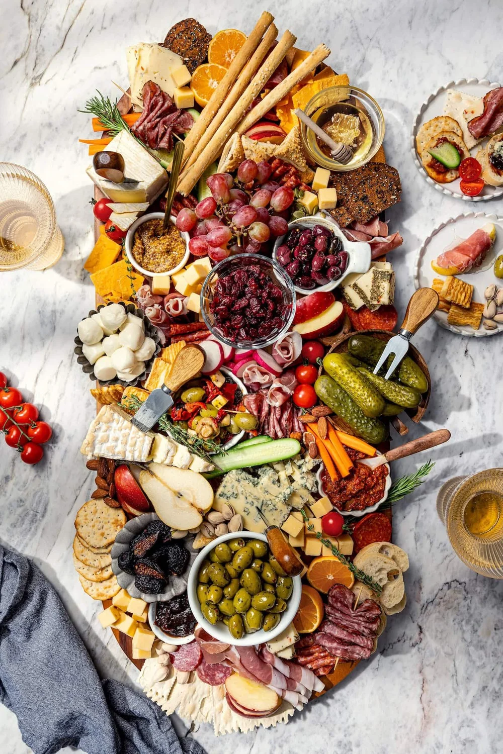 Charcuterie and cheese board with cured meats, cheeses, fruit, olives and crackers