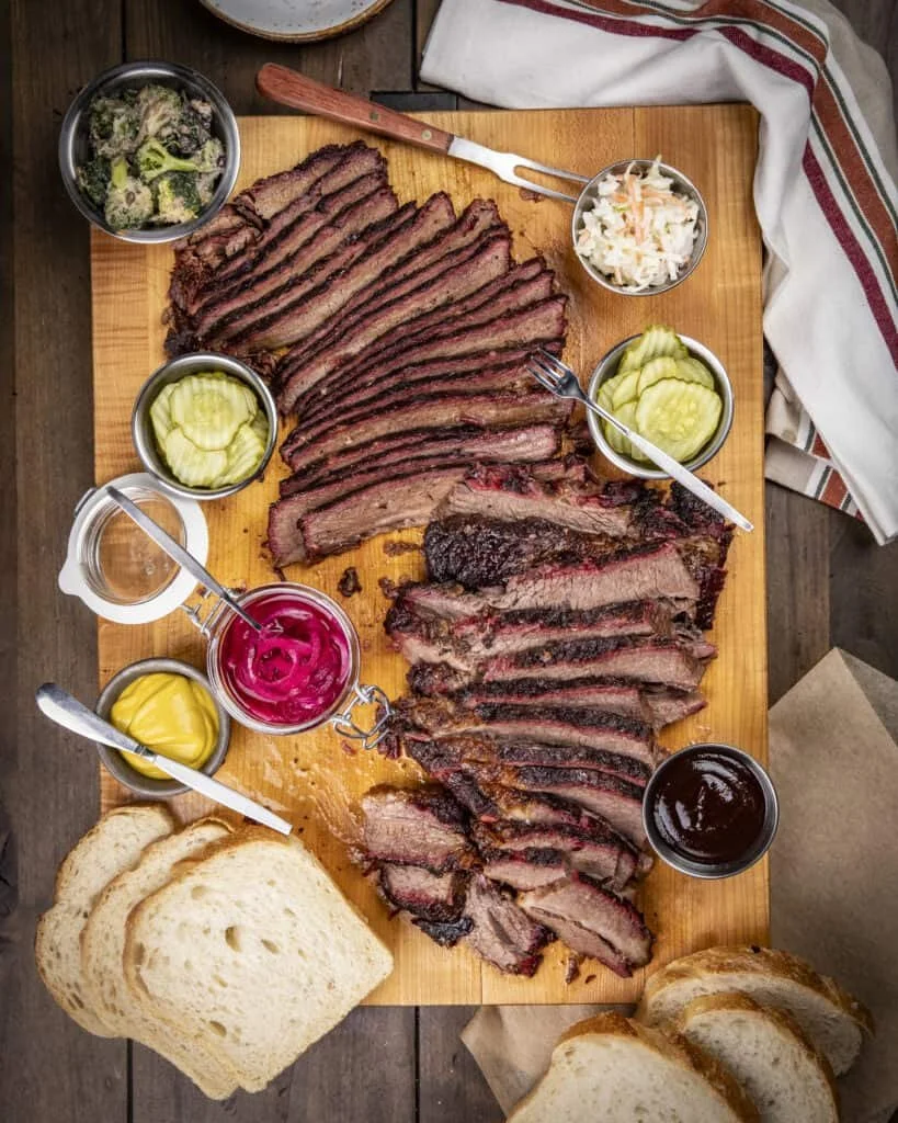 Sliced smoked beef brisket with a dark seasoned bark