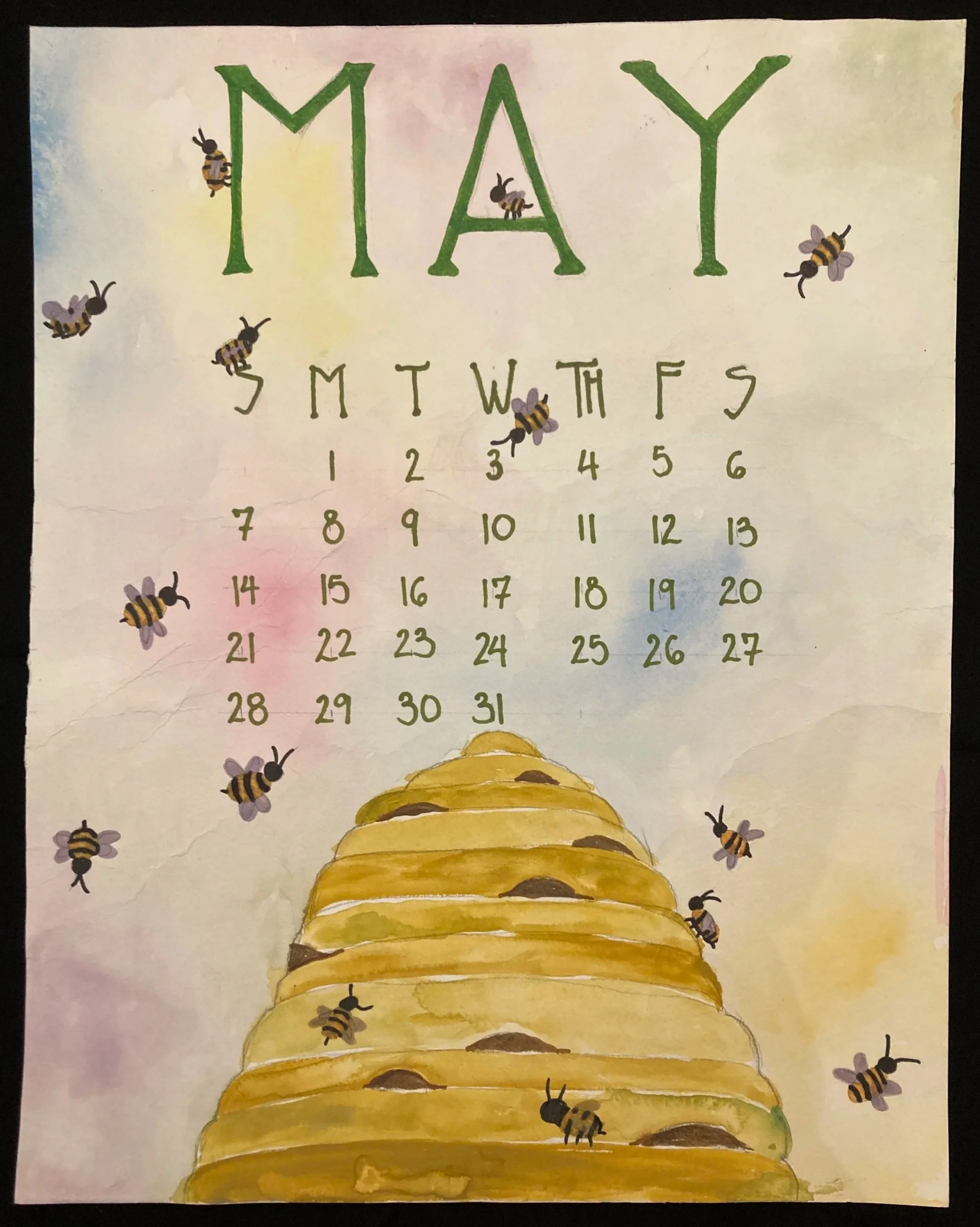May calendar with bee illustrations and a honeycomb illustration at the bottom.
