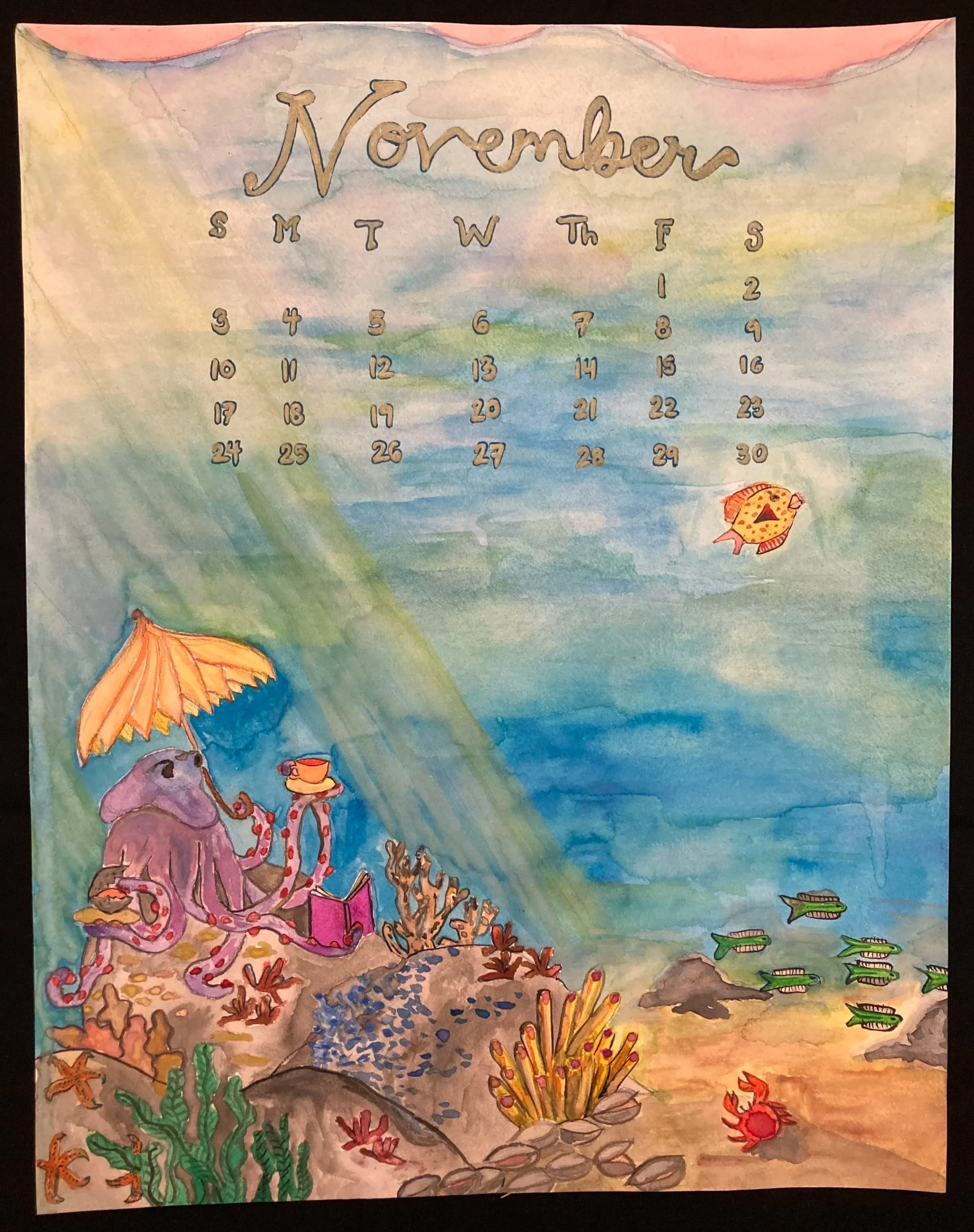 A watercolor illustration of an underwater scene with a purple octopus sitting under a yellow beach umbrella, reading a book, and holding a cup of tea. There are aquatic plants, rocks, a small red crab, a school of green fish, an orange pufferfish, and a starfish. A calendar for November with dates and days of the week is at the top.