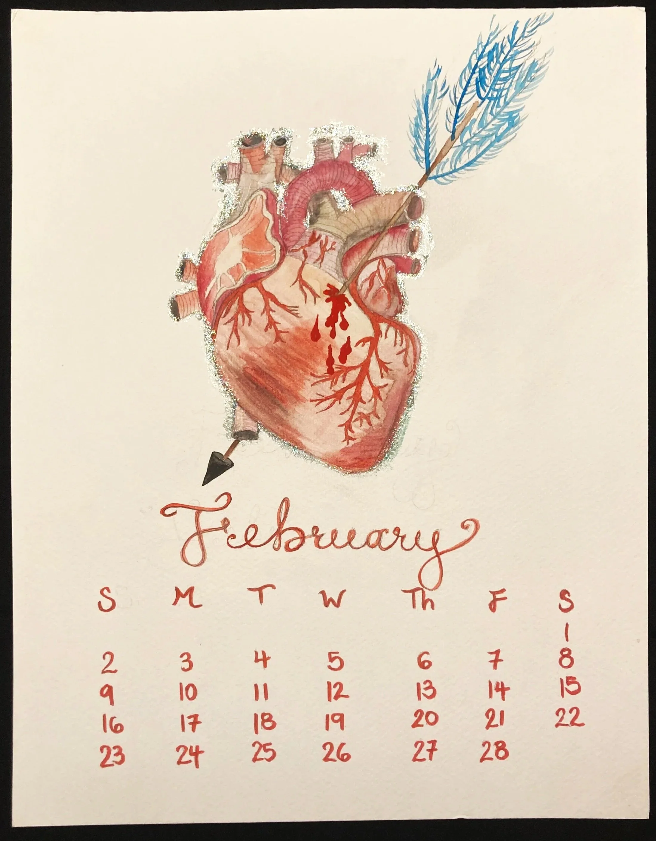 Calendar page for February with an illustration of a human heart pierced by a blue arrow.