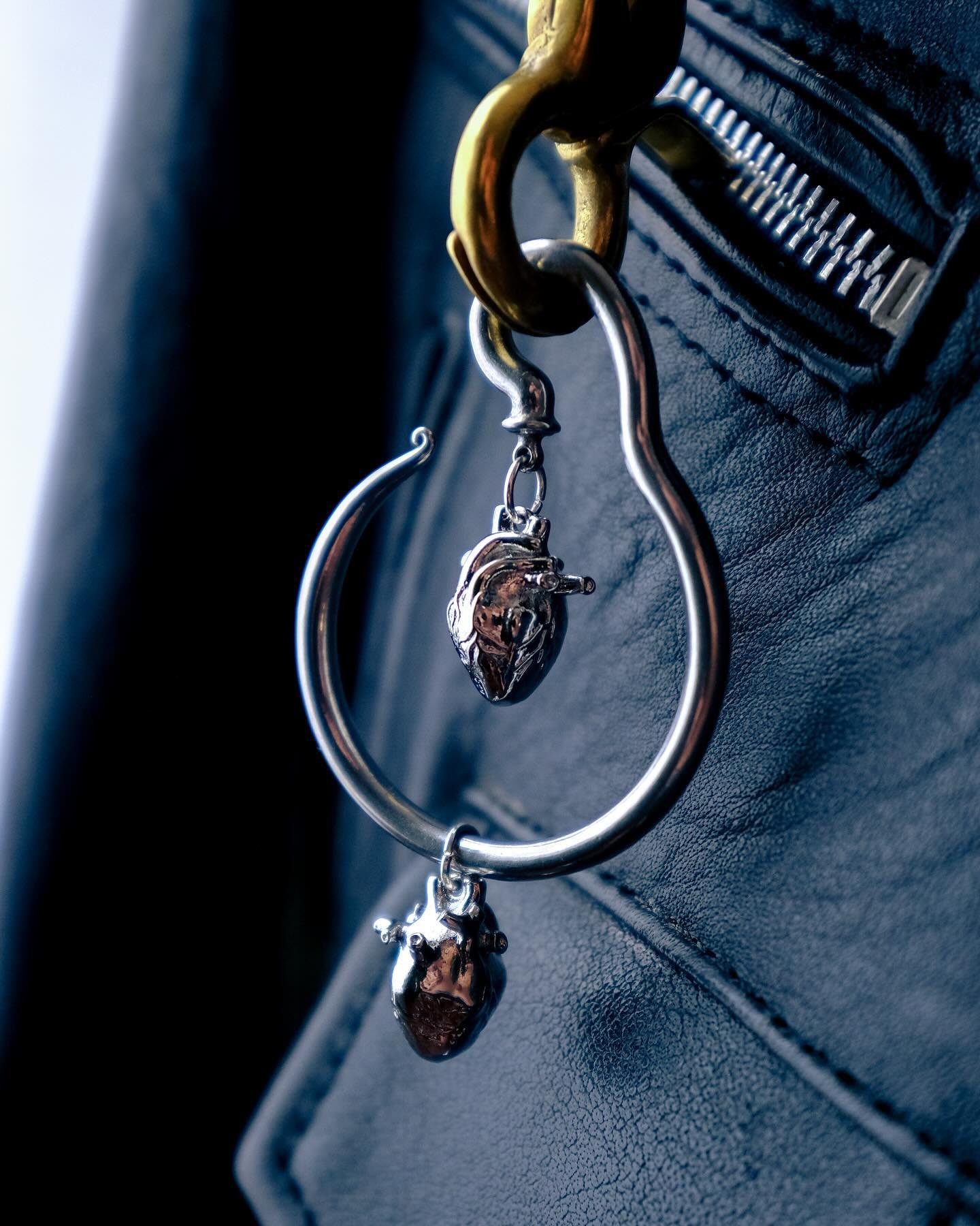 No one thing we do or express does not affect the other. We can not pretend that the actions of the other do not affect the self. Everything important hangs in this balance.

Rhodium plated stainless steel hearts. Stainless steel 4mm (6g) hanger. Sol