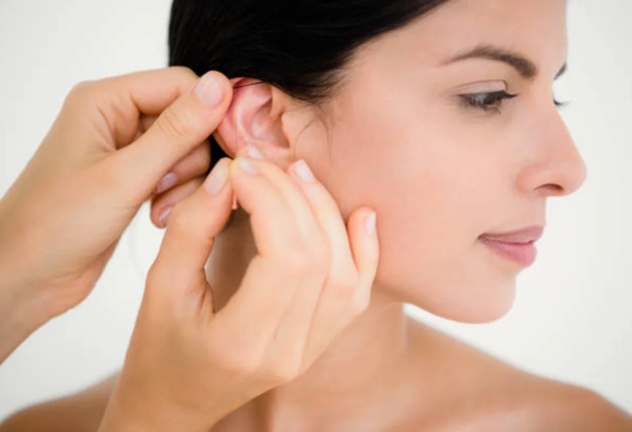 Patient receiving auricular acupuncture at Empirical Medicine in Glendale, AZ