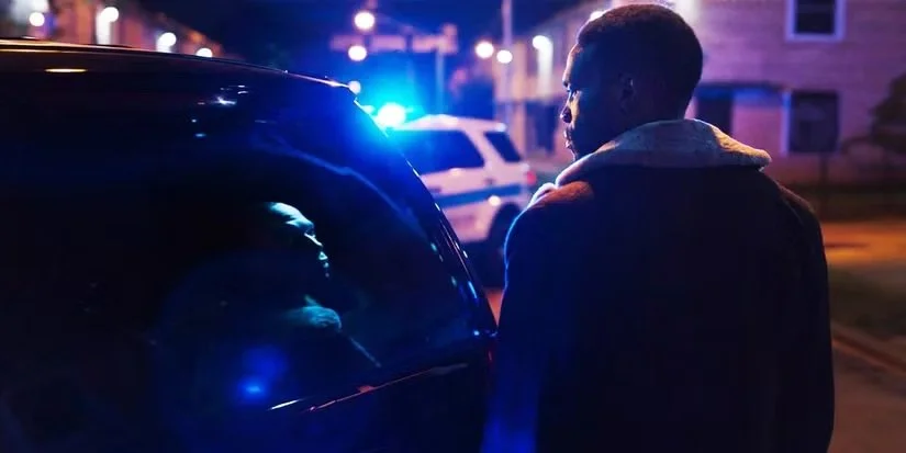 Candyman-standing-next-to-a-police-car.jpeg