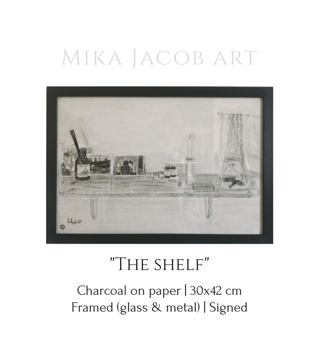 A framed charcoal drawing titled 'The Shelf' depicting a cluttered shelf with various objects including bottles, photographs, a candlestick, and miscellaneous items. The drawing is signed by the artist Mika Jacob.