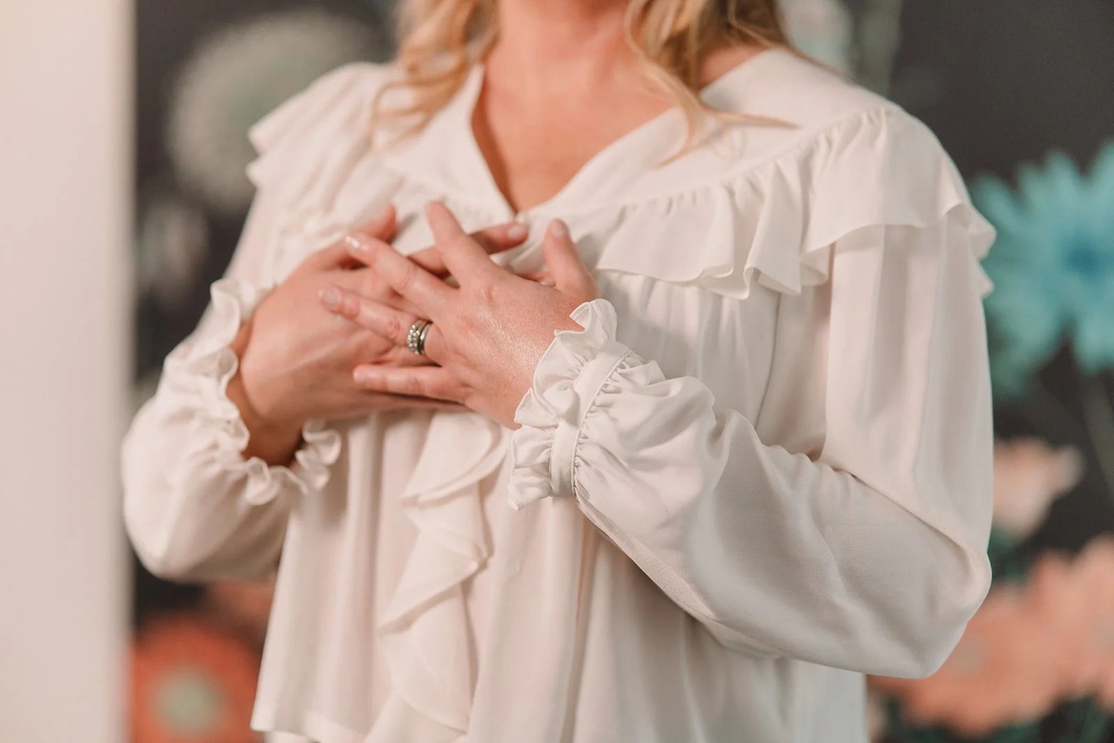 Hands placed over the heart, symbolizing self-compassion, presence, and embodied healing in holistic practice.