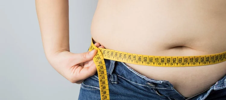 Measuring tape around the waist — central weight gain and metabolic syndrome evaluated by endocrinologist Dr. Farhad Hasan near Pittsburgh