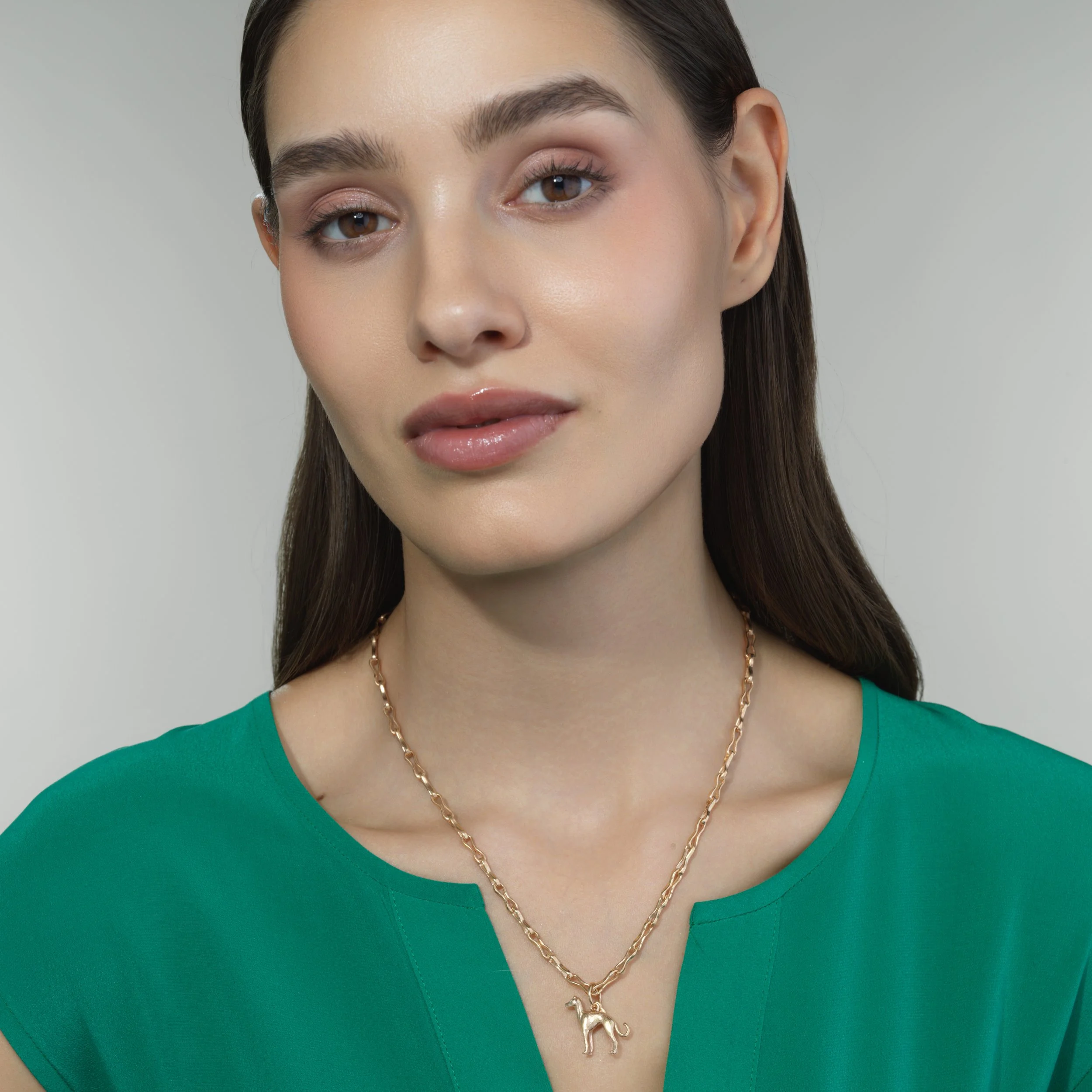 Italian Greyhound gold pendant shown on a model for scale