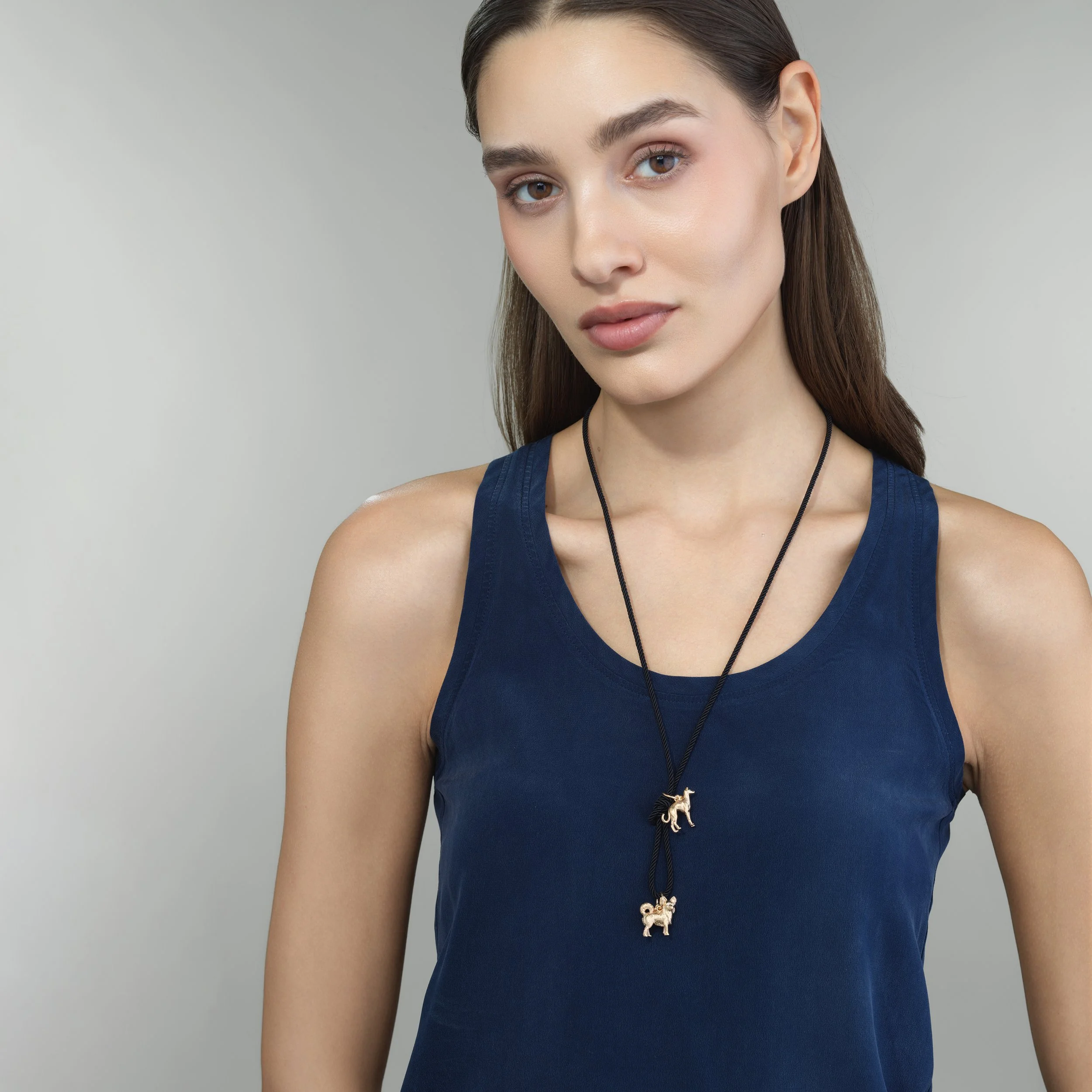 Italian Greyhound gold pendant shown on a model for scale