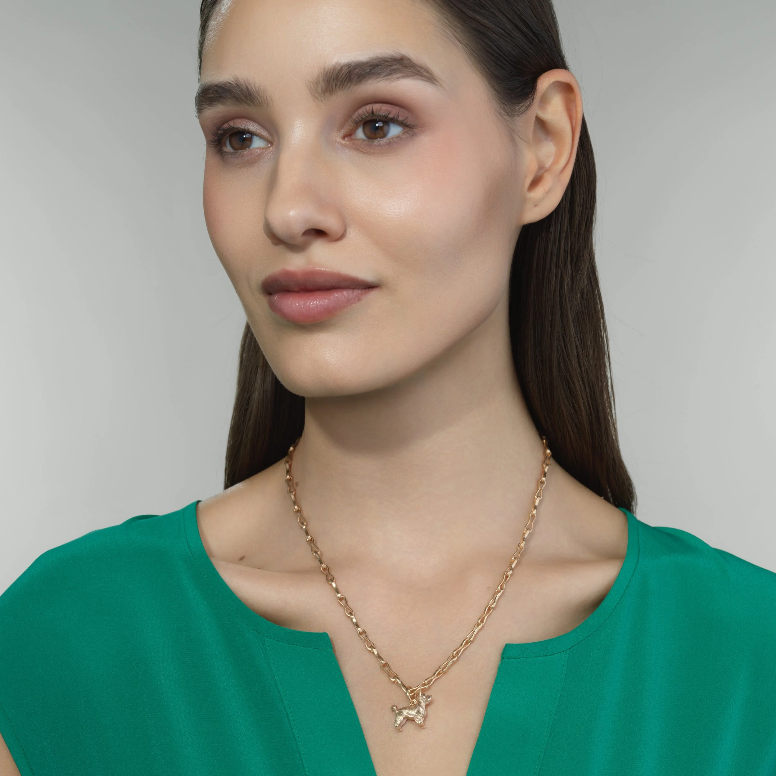 Yorkshire Terrier gold pendant shown on a model for scale