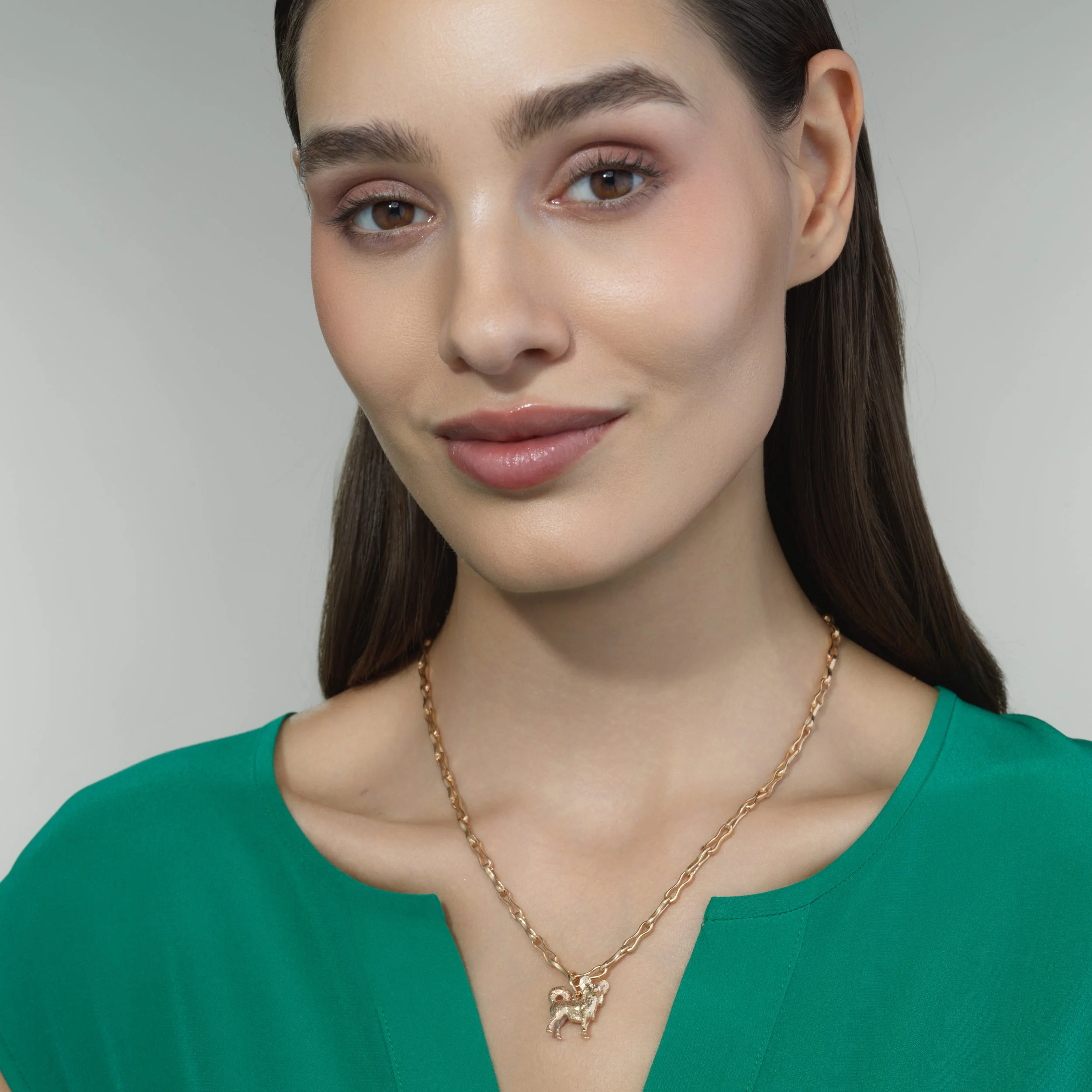 Long-hair Chihuahua gold pendant shown on a model for scale