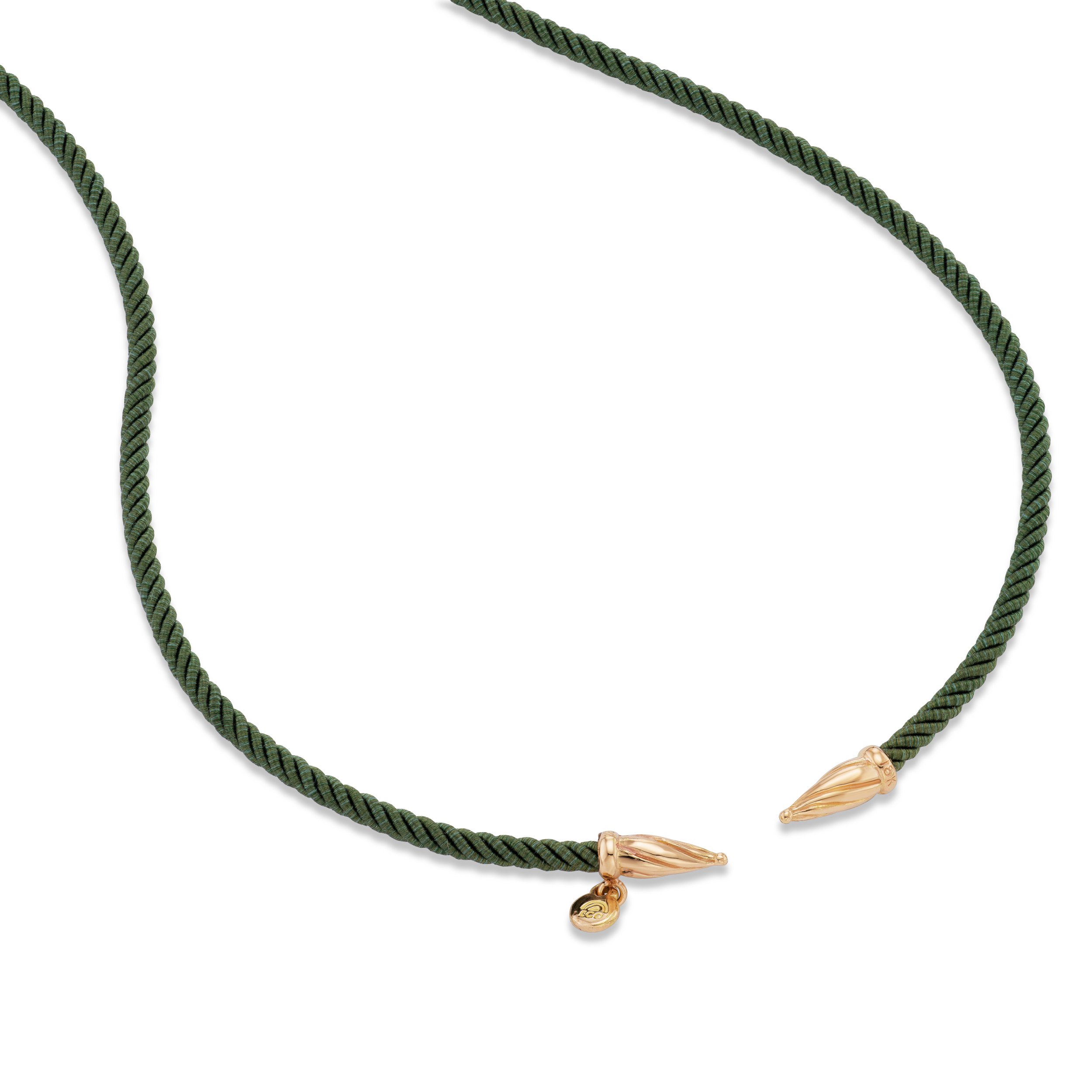 Green silk cord necklace with 18k gold ends, close-up view