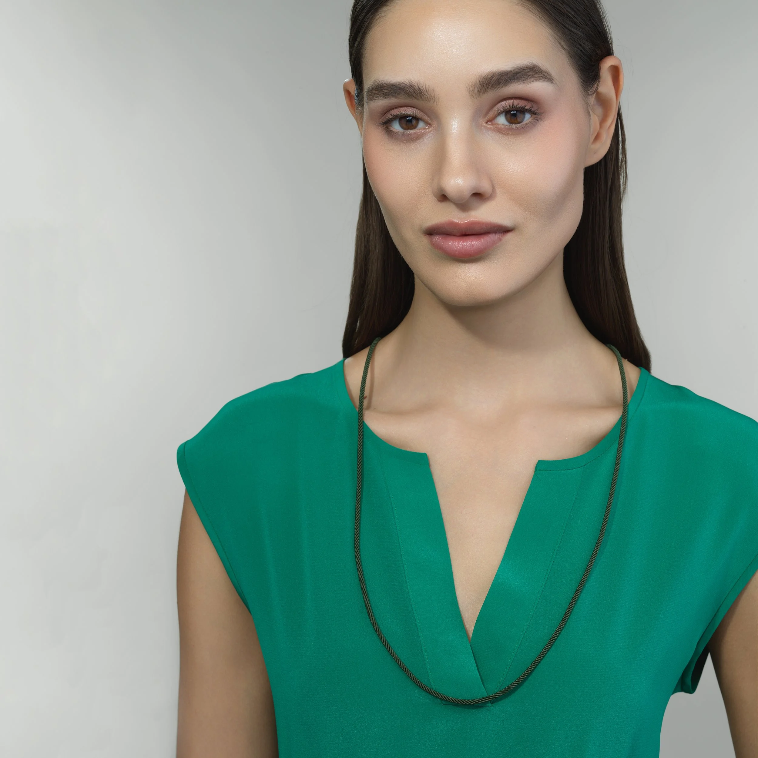 Green silk cord necklace shown worn on a model for scale