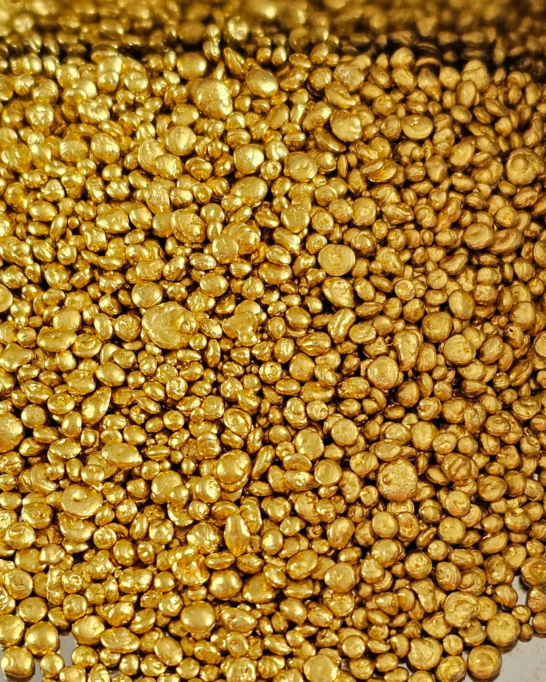 Close-up of numerous small, shiny, gold-colored balls.