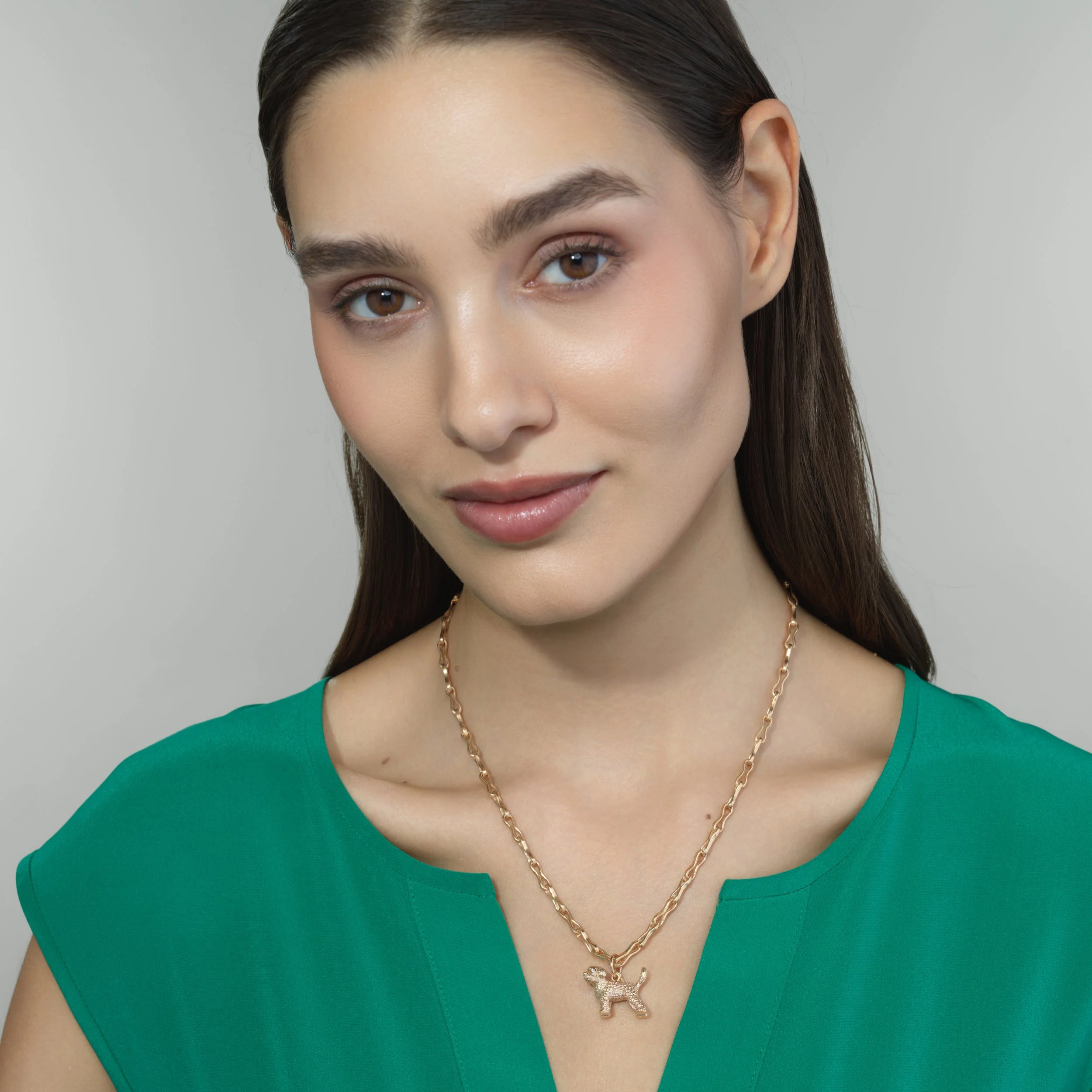 Toy Poodle gold pendant shown worn on a model