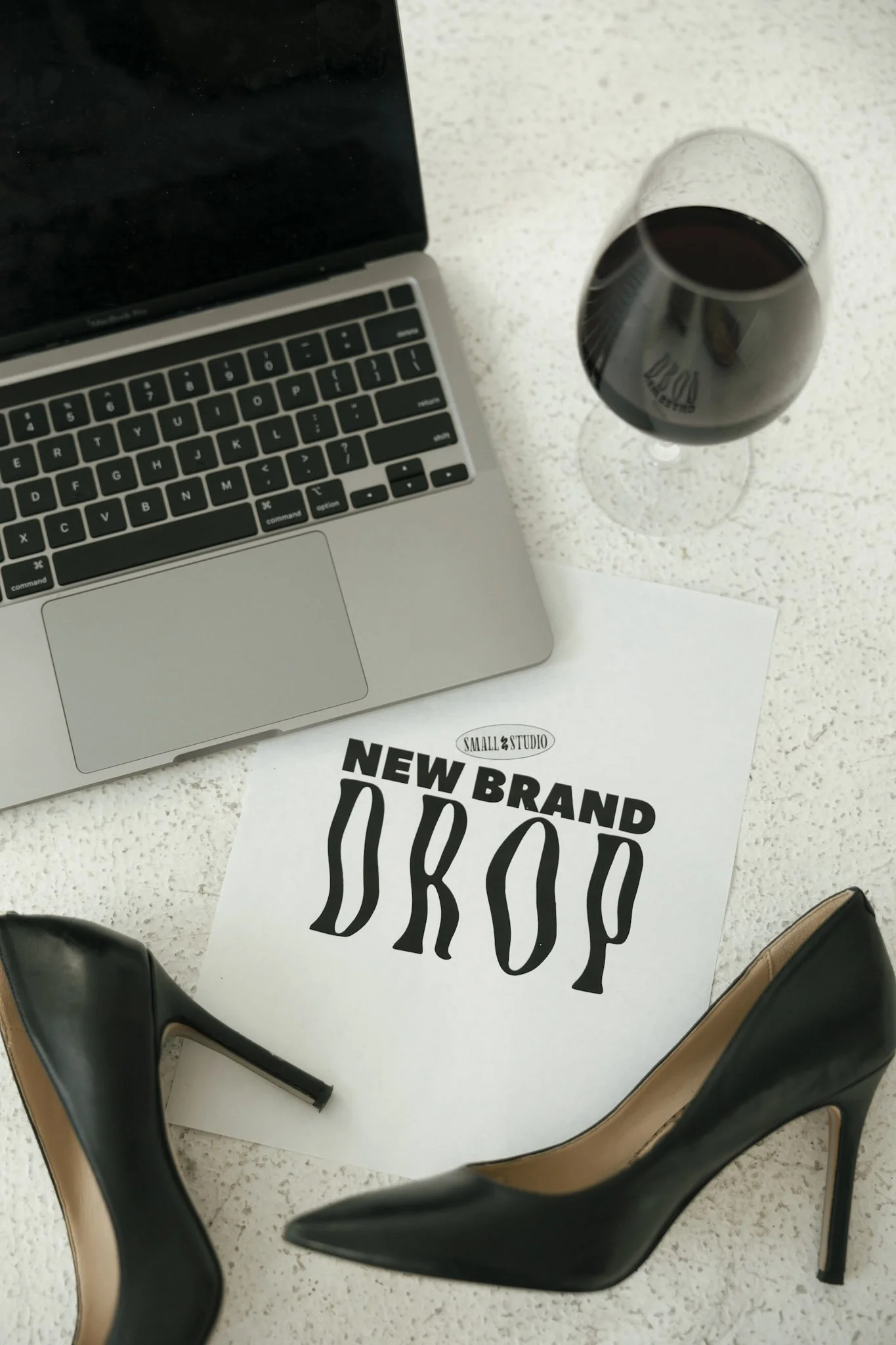 Small Studio new brand drop document on desk with laptop showing business branding project completion