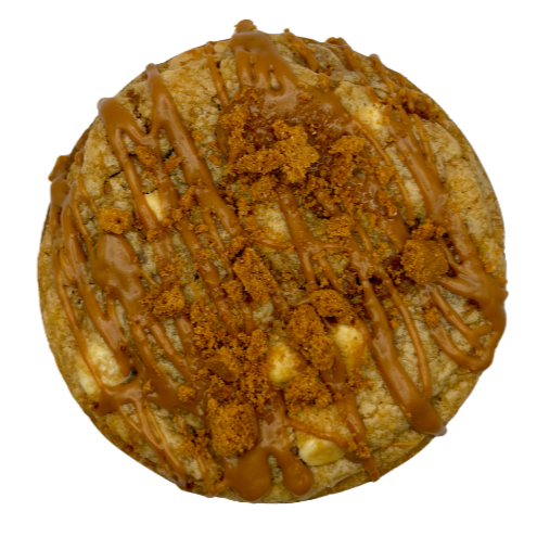 A stack of four colorful cookies topped with multicolored candy pieces and scattered chocolate chips on a white marble surface.