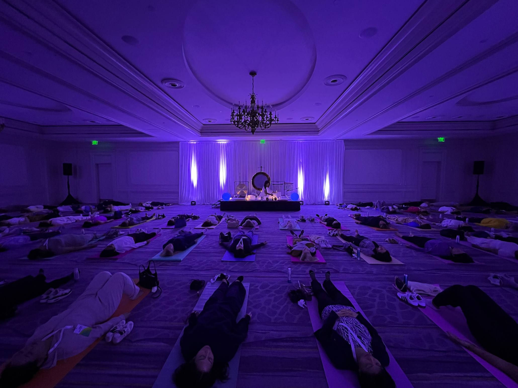 Large corporate group wellness retreat, group sound bath meditation in ballroom, by 1111 Sound Healings at The Ritz Carlton Naples.