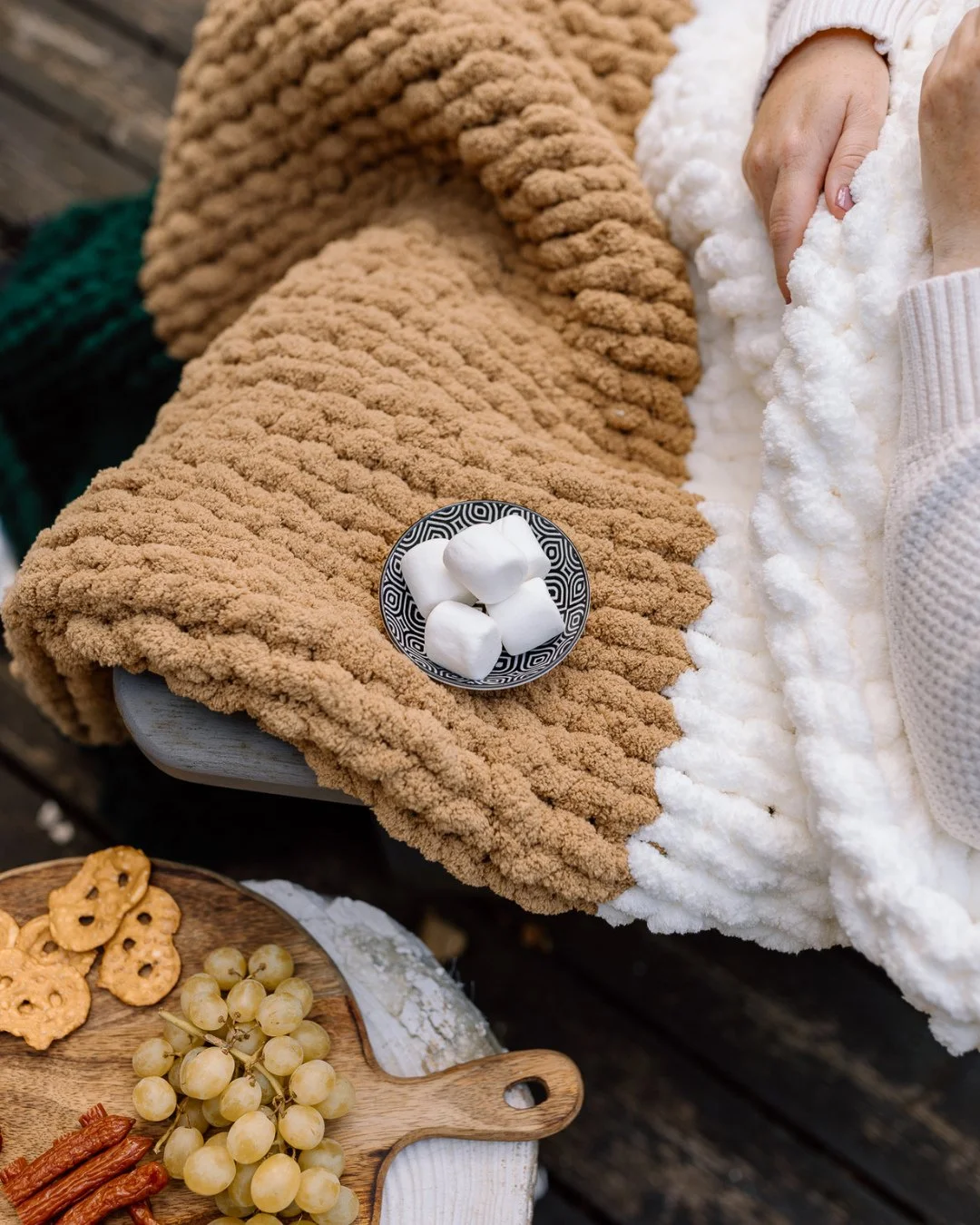 Golden hour, good snacks, a crackling fire ⁠
⁠
&hellip; and a NICNAKKNITS blanket to keep the chill away. 🔥⁠
⁠
The perfect recipe for fall evenings outdoors. 🍂⁠
⁠
Stay warm + comfy this season, shop your cozy companion at nicnakknits.com (link in b