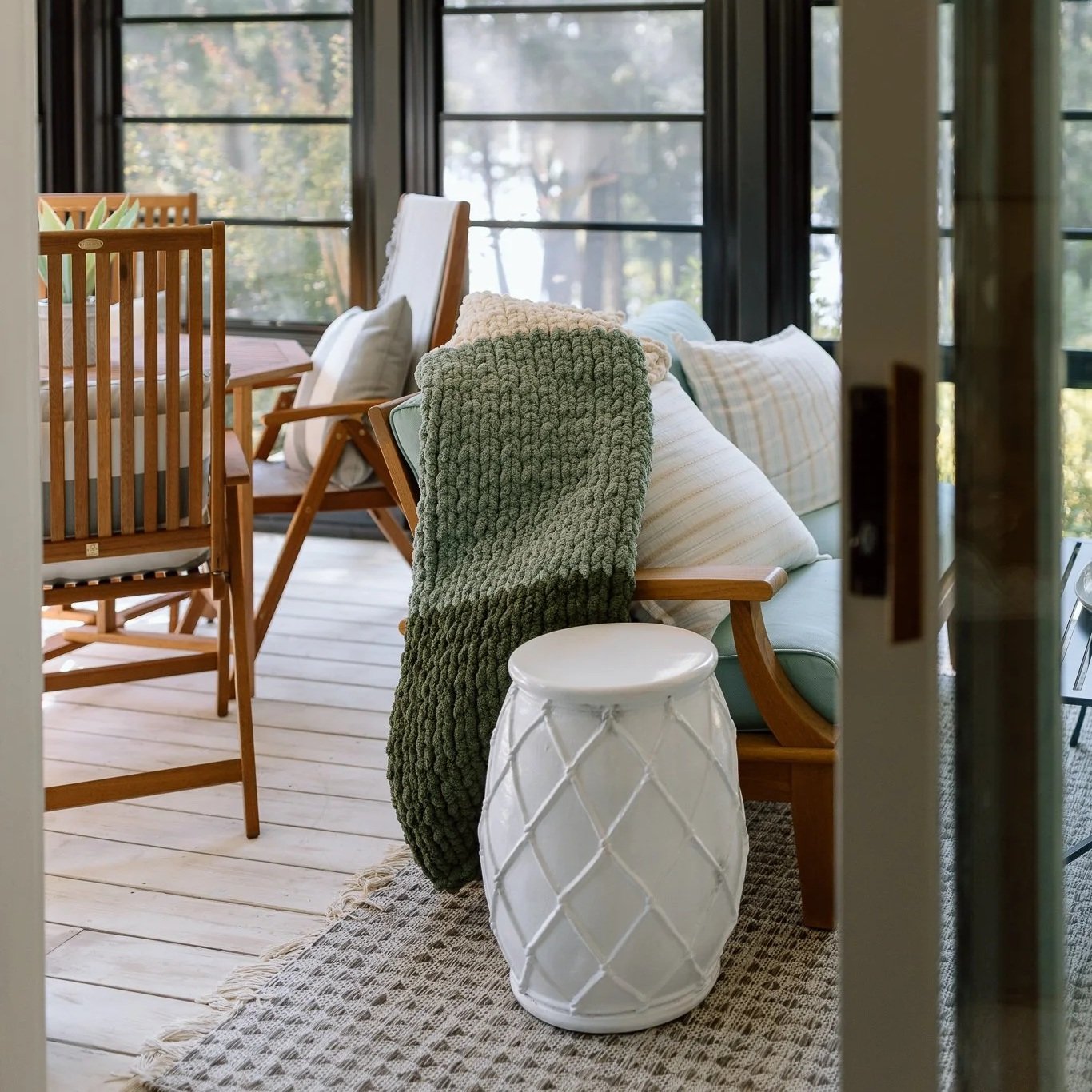 The Alexandra chunky knit blanket styled on a bed