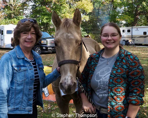 Two women and horse, looking at camera