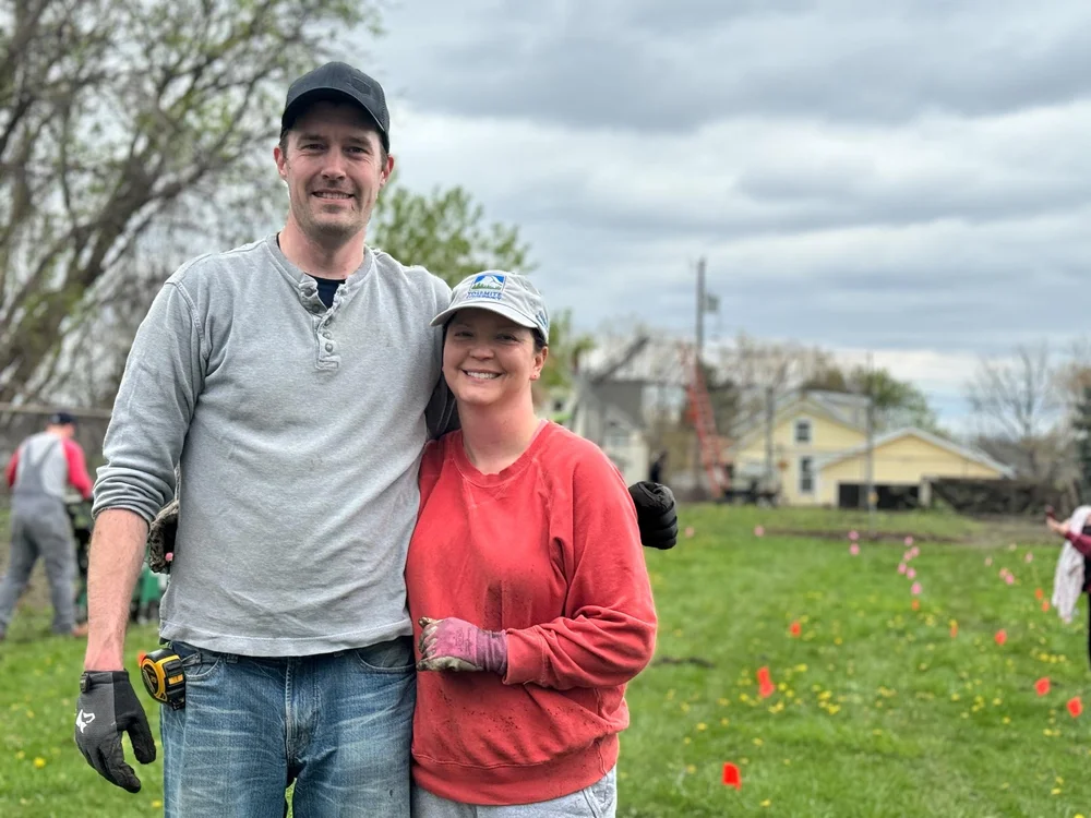 A couple taking a break from gardening.