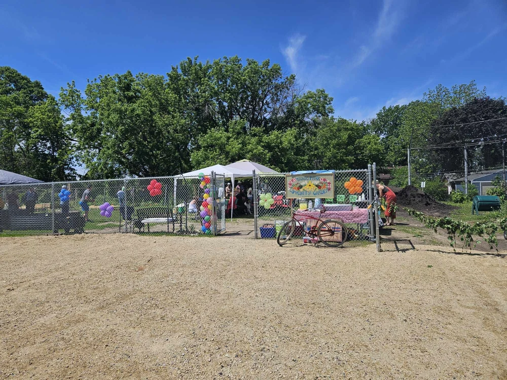 A far-away shot of the Garden set up and ready for the Grand Opening event for the Mounds Park Community Garden.