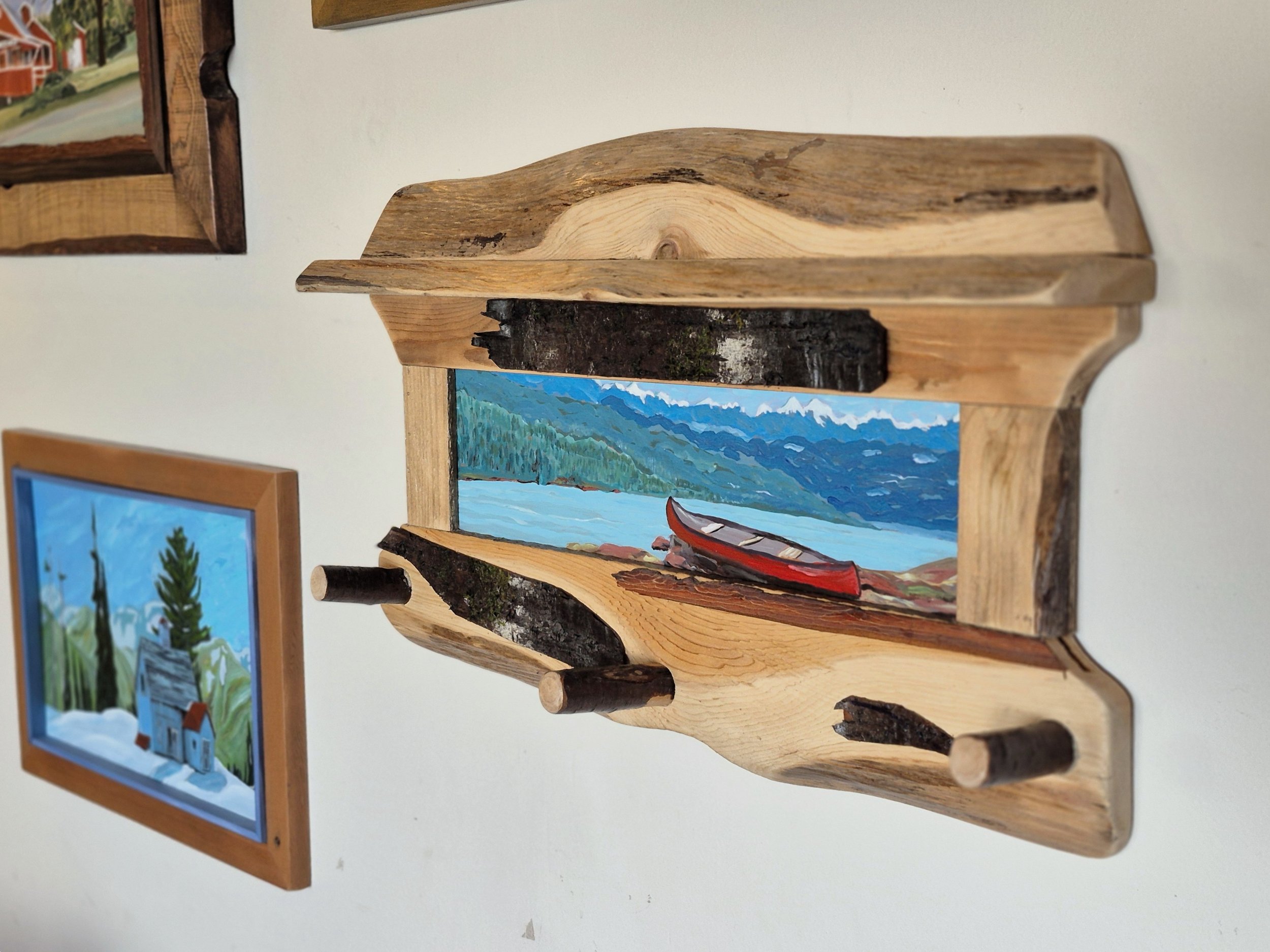 Here is a rustic shelf and coat/hat hanger with a painted panel inset. It seems like a logical evolution from the rustic frames.